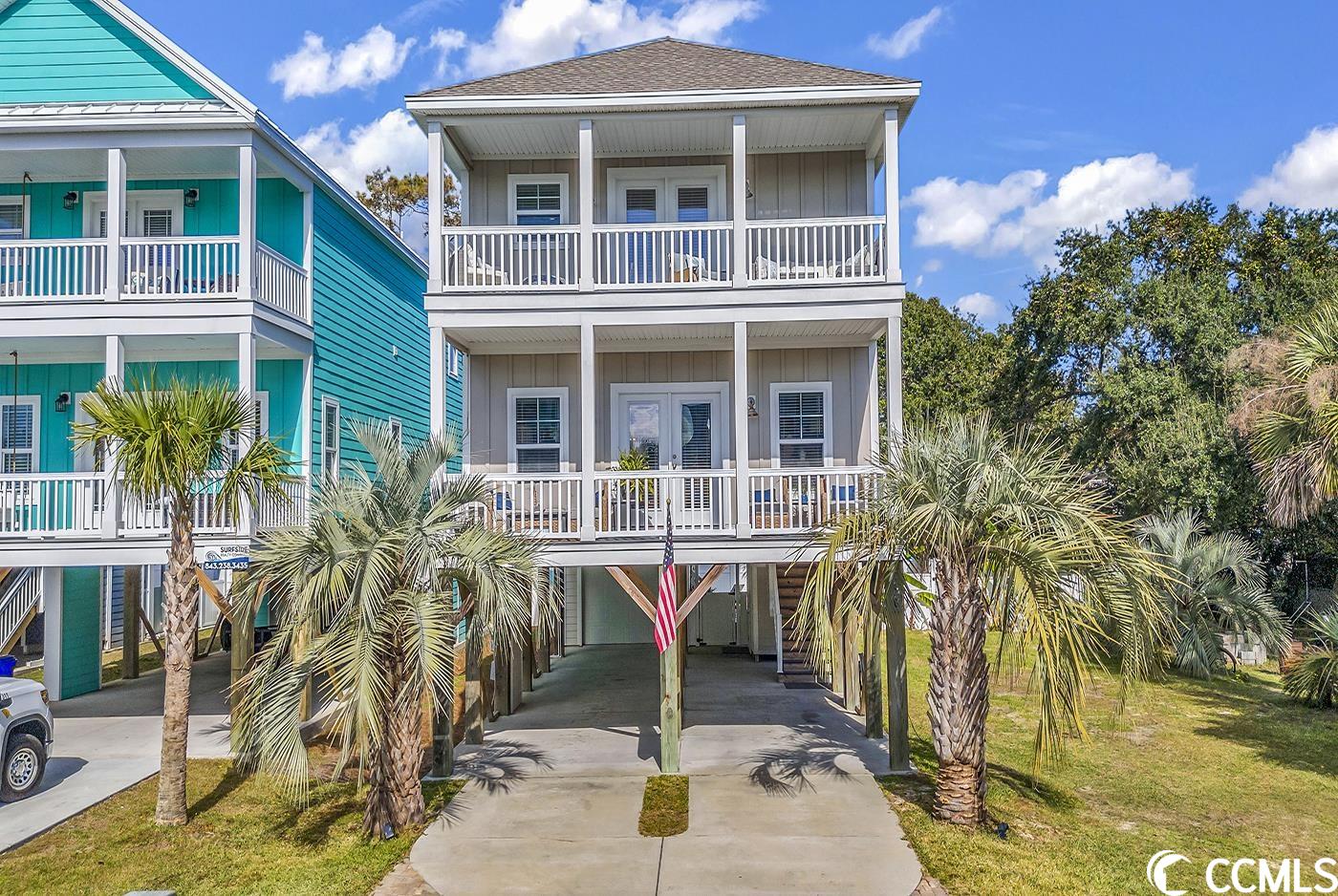 introducing the surfside beach lifestyle: only one block from the ocean! this raised beach house checks all the boxes of a perfect primary residence or investment property with the added bonus of short-term rentals. built in 2019, this home features hardie board siding, an outdoor shower, three decks, a covered patio, a 12'x23' in-ground pool, and an oversized garage that not only safeguards your pool equipment but also provides ample space for a golf cart and bicycles.  use the interior elevator to reach the main level and enter a stunning open-floor kitchen, dining, and living area. the kitchen has stainless steel appliances, granite countertops, contemporary lighting, and an under-counter wine cooler. the expansive 24' width of this floor plan creates a roomy and open atmosphere, perfect for all your entertaining needs. french doors off the living room lead to a 24'x7' covered porch. one bedroom and full bathroom are located on the main level, with sliding doors leading to the back deck overlooking the private pool.venture upstairs to discover four more bedrooms, including a generously sized 17'x13' master suite. the master suite is well-appointed, featuring a walk-in closet, a double sink vanity, and a luxurious oversized garden tub/shower. adding to its charm, the master suite has its own private covered porch. this home is built for a crowd with a large laundry utility room with a mop sink and two hot water heaters. parking is a breeze with ample space beneath the home, and the driveway is extended and beautifully bordered by double palm trees. all measurements and square footage are approximate and not guaranteed. buyers should verify.