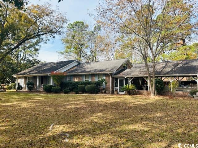 one acre corner lot! this low country home is located in the perfect area to have some space! large four bedroom four bath home with a giant kitchen for entertaining and cooking, formal dining room, formal living room, family room, built-in book cases and large deck off the back. there is a back area with workshop. with a little updating and tlc, it will be the perfect family home. this home is in being sold as-is in an estate sale.  close to the beach.