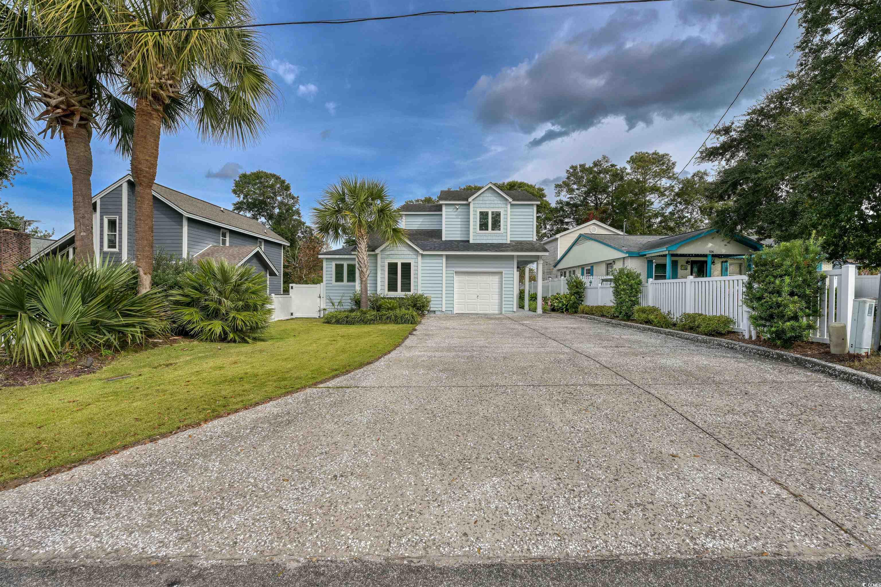ocean drive beach is where you will find this awesome beach cottage!  near mclean park, near main street, and just a few blocks from beach!  you can golf cart everywhere!  this home has a great one car garage which is perfect for your beach items and golf cart.  this home has awesome curb appeal the minute you drive up!  mature landscaping, wide oyster shell finish concrete driveway, and the exterior color is beautiful and beachy!  the front door you will find on the right side of the home – just down a covered sidewalk and front porch!  as you find your way inside – you will be greeted with a “cute as a button” a- ha moment!  the high ceilings in the living room, kitchen and dining room – make this place even feel bigger than it is!  the living room has a gas fireplace, high ceilings with ceiling fan, plant shelf and luxury vinyl plank flooring.  the dining room is all overlooking the oasis backyard with many picture windows and high ceilings.  the kitchen!!  oh, my goodness! it is so awesome with a large breakfast-entertaining bar, upgraded white kitchen cabinets, stainless steel appliances, lovely backsplash, granite counter-tops, high ceilings, and it all overlooks the awesome backyard and screen porch!  the kitchen cabinets have so many features like a hidden coffee bar, gourmet mixer compartment (that lifts when in use), pull out cabinets upon pull out cabinets, no space not used here! this kitchen is made for entertaining and gourmet cooking for sure!  the master suite is on the first floor – just down the hallway – past the lovely guest powder room!  the master suite bedroom is very spacious – with many closets – one nice size walk-in closet and one regular closet.  both with beautiful barn slide mirror doors.  the master bath is also renovated and is spa-like!   the master bathroom features beautiful, tiled flooring, double sink vanity with makeup station, standalone kohler air bubble massage tub, large tiled walk-in shower with beautiful glass doors, lots of cabinets and linen storage, and large water closet.  it is absolutely beautiful!  on the first floor you will find a lovely laundry room with cabinets galore!  this homeowner uses some of it as a pantry!  the one car garage is just beyond that awesome laundry room.   upstairs you will find two spacious bedrooms with closets, one is currently used as an office/ bedroom, this bedroom has a murphy bed.  the guest hall bath is spacious with tub/shower combo.  let’s make our way to the backyard!  there is access through the dining room – the glass door takes you to the nice size screen porch!  this is where you will find the truly amazing backyard oasis!  it has mature landscaping, irrigation, pavers galore, dining area, cooking area, outdoor living area, wood burning fireplace, string lights poles, fenced in backyard, and storage building.  the home other features are luxury vinyl, upgraded carpet upstairs, murphy bed, rinnai water heater for downstairs, plantation shutters, kohler air bubble massage standalone tub, storage building, gas fireplace inside, wood burning fireplace outside, new fence, completely new landscaping with irrigation to just to name a few.  the complete list will be inside the home! north myrtle beach is where this home is located and just two blocks from main street where all the festivals and concerts are held throughout the year!  nmb has lots to offer and first of all it has the widest beaches around plus nmb residence free parking, parks galore – mclean park is just a few blocks away – great from walking the doggies, it has tennis and pickle ball courts, playground area, and grilling areas as well. the location of this home – is very well sought after and these do not come up often.  no hoa here and you can bring your boat, golf cart and park your rv in the front!  hurry up, this gem will not last long!