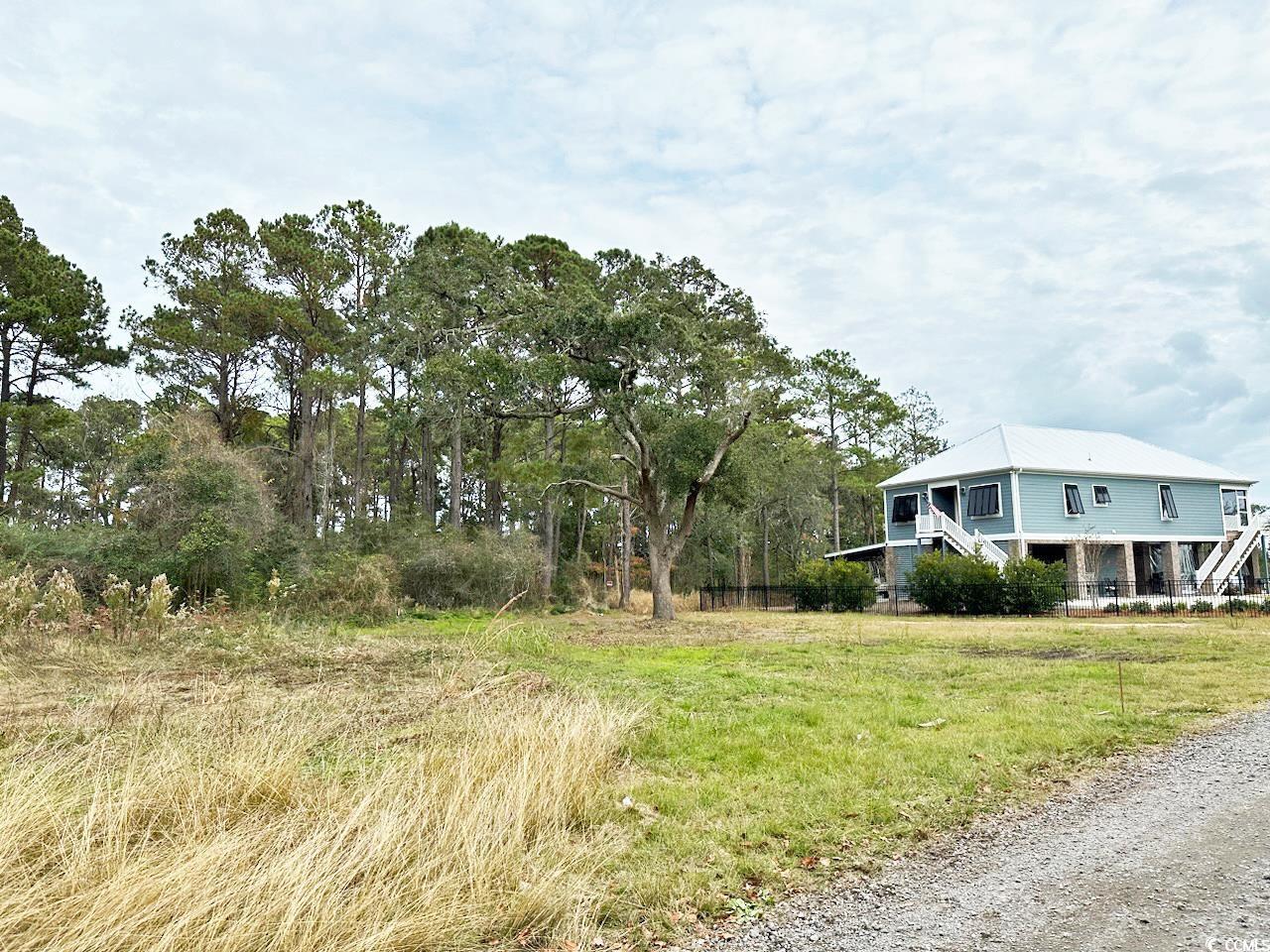 capture a piece of coastal living on this cleared lot! located on mainland pawleys island, this small niche creek front community provides an opportunity to get on island time, starting with no hoa. constructing a two-story raised beach house on this lot could capture refreshing sea breezes as well as a spectacular ever-changing, dawn-to-dusk inlet view. the adjacent estuary provides a private natural backdrop providing hours of birding right at your doorstep. public water and sewer are accessible from the road. seller has two plans available; both could provide a great view. plan i: 2740 sq ft, 2 levels, 4 br/3.5 ba. plan ii: 1700 sq ft, 1 level, 3 br/2 ba. this property is centrally located to the beaches, golf courses, shops and dining. plus close proximity to highway 17 but a world away!