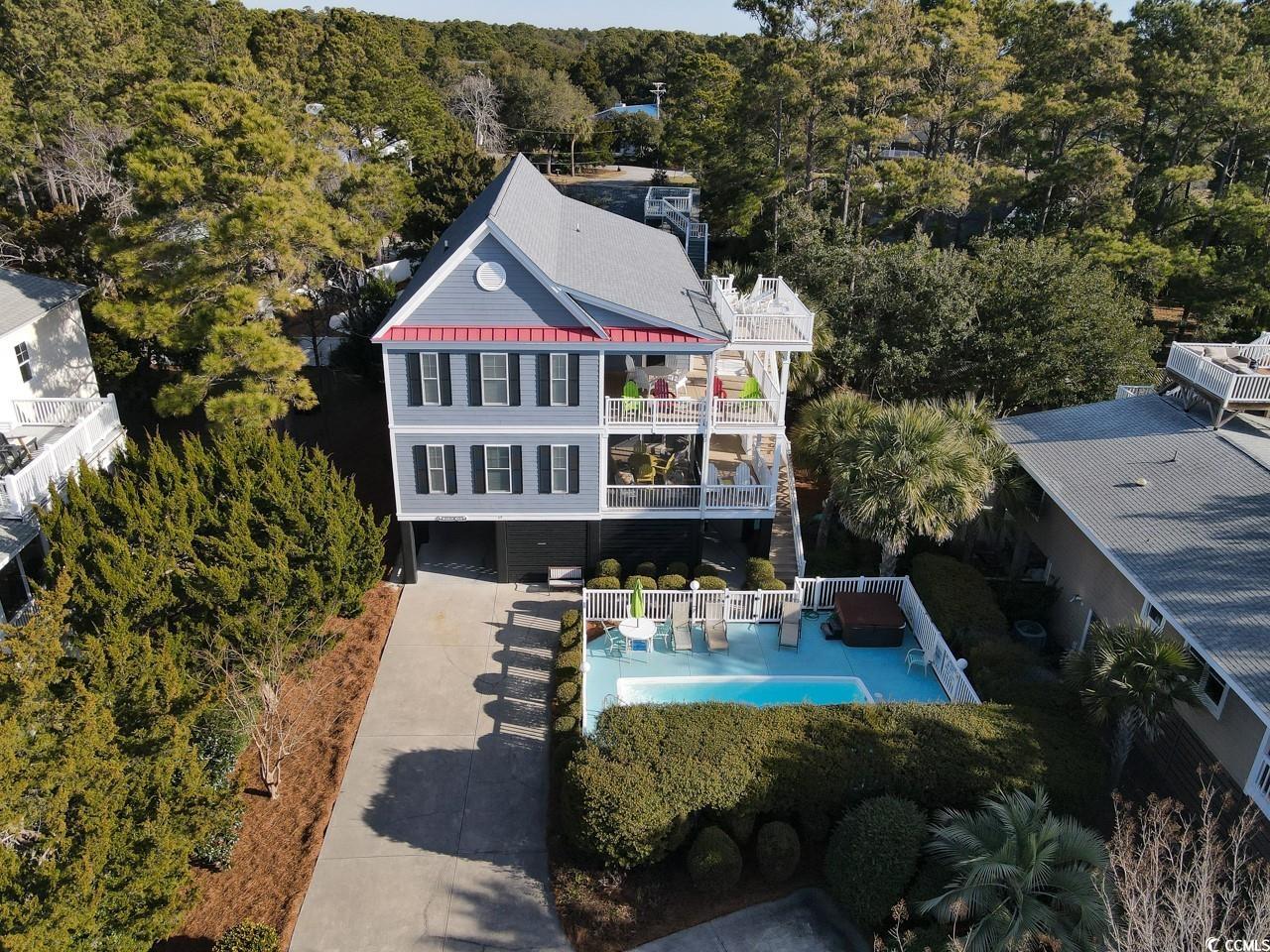 discover the epitome of seaside living in this magnificent 6-bedroom, 6-1/2 bathroom raised beach house. in the highly sought-after north litchfield neighborhood, this property is not just a home; it's a lifestyle. imagine waking up to the soothing sounds of the ocean and the gentle rustle of palm leaves, all just steps away from the pristine beach. with 3558 square feet of carefully crafted living space, this residence is designed for comfort, relaxation, and entertaining. as you step inside, a comfortable and spacious interior unfolds, featuring a seamlessly flowing layout that accommodates both intimate family moments and large gatherings. the elevator adds a touch of convenience, ensuring accessibility for everyone. escape to your private oasis with a refreshing pool and a luxurious 6-person hot tub – the perfect setting for creating cherished memories with family and friends. whether you're hosting a summer barbecue or simply enjoying a quiet evening under the stars, this retreat is your personal haven. the allure of 69 belvedere lane extends beyond its walls. the property effortlessly sleeps 17, making it an ideal investment for those seeking a vacation rental opportunity. the annual rental revenue is extremely impressive and is among the highest in all of north litchfield beach. let the property work for you, providing a steady stream of income while you indulge in the coastal lifestyle whenever you desire. location is key, and this house delivers. with the beach just a short stroll away, you'll enjoy the best of coastal living without sacrificing the serenity of a quiet neighborhood. the allure of north litchfield surrounds you, promising a lifestyle that embraces both relaxation and adventure. immerse yourself in the charm of coastal living, where every detail has been thoughtfully curated to provide you with a lifestyle that's not just lived but celebrated. don't miss the chance to make 69 belvedere lane your home. it's more than a property; it's an invitation to embrace the coastal lifestyle, where comfort and the beauty of nature converge. seize this opportunity and step into a life of seaside bliss!