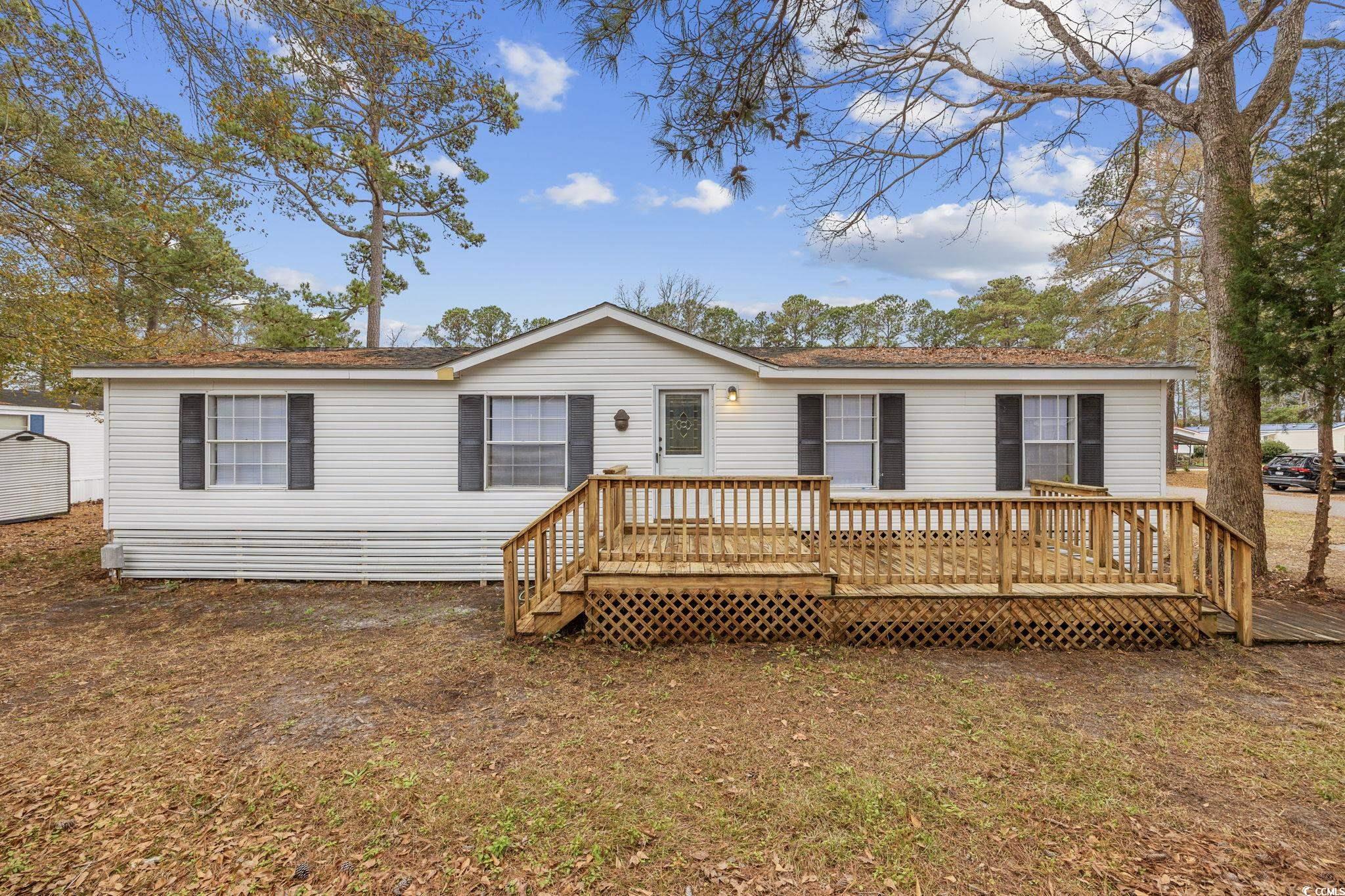 experience coastal living in this delightful 3-bedroom, 2-bathroom double-wide manufactured home within the peaceful windjammer village. this property is the perfect blank slate and ready for new owners. the interior has been refreshed and features a spacious living area, an inviting kitchen, and a large outdoor deck perfect for grilling and entertaining. enjoy the community's amenities, including a pool and clubhouse. this home is centrally located just moments away from some of the areas biggest draws. hop on your golf cart and enjoy the sun-drenched beaches and fishing off the garden city pier. or explore the lively bars and restaurants along murrells inlet marshwalk, or reconnect with nature at nearby brookgreen gardens and huntington state park. whether you're searching for a permanent residence or a vacation retreat, this property encapsulates the essence of coastal charm. book your tour today!