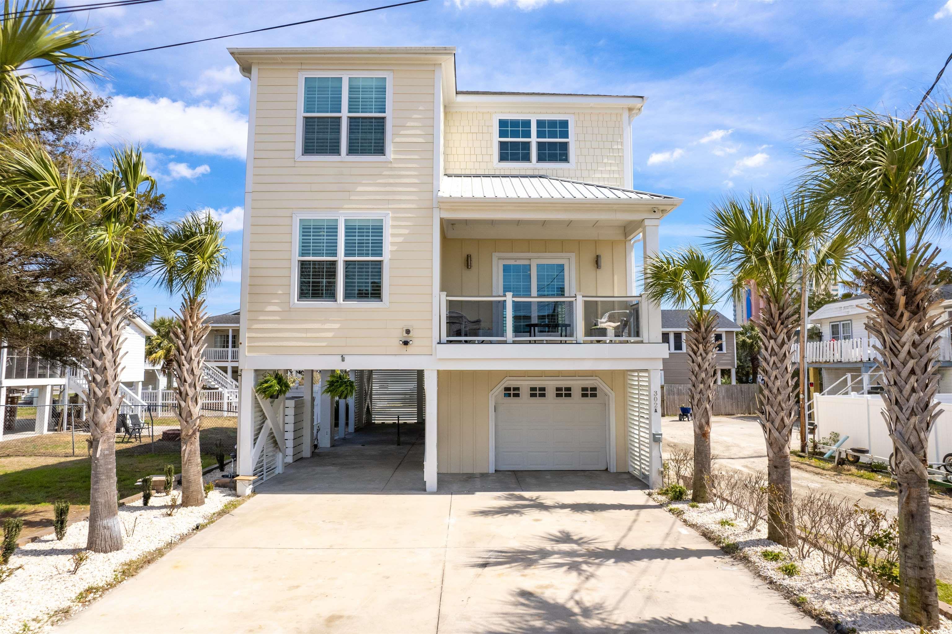 **you need to see the live video of cherry grove and this home! ask you agent for the link!** located in cherry grove in north myrtle beach! this home is located just little over a block from the famous cherry grove beach pier and the beach! this wonderful home is also located close to the cherry grove boat ramp for you to get out of the water at cherry grove and take hog inlet out to the ocean! the home itself is 4 bedrooms, 4 baths, with a garage, and parking with storage underneath! enjoy the extremely high ceilings throughout the main living space of the home. out back is two decks and at the front of the home is a large balcony. watch the video to experience this home!