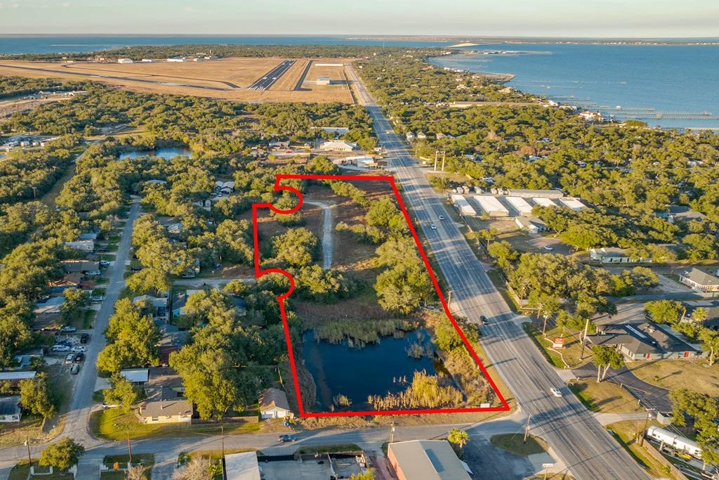 Great opportunity 6.5 Acres of prime location in Fulton(Rockport) for development with over 733 ft of HWY 35 Business frontage, corner lot with small pond, mature wind swept oaks and second road access! City water and sewer available.