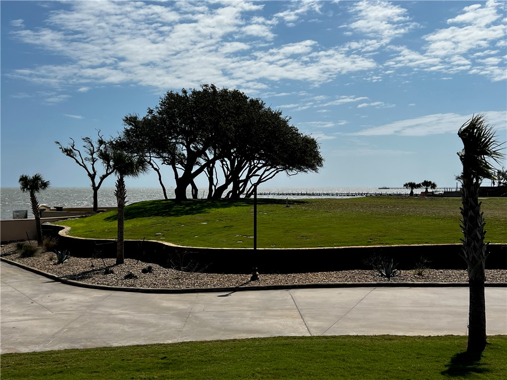 It’s time to own your own exclusive inner sanctum in Royal Oaks! Build your custom exceptional waterfront estate on this oversized lot with 180 degree view of Aransas Bay. Wake to the endless sunrises glistening over the Aransas Bay and sweet sounds of the water from this 21312 sf lot. Royal Oaks is a world unto itself umbrellaed with enchanted windswept Oak trees, sprinkled with sitting areas, walking trails lit with quaint light posts. The tastefully designed neighborhood is gated with easy access to highway 35 and its main entrance fronting Fulton Beach Rd. The cobble stone entrance with guard house meets with the storybook curved stucco and stone privacy fence lining the front and back of the development providing next level privacy. Molded for prestigious living, you will adore the amenities including the two putting greens, stone gazebo with brick fire pit and lighted pier with fish cleaning station.