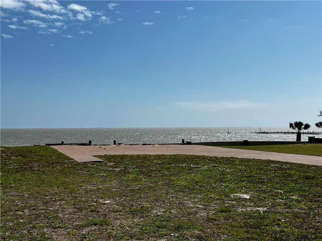It’s time to own your own exclusive inner sanctum in Royal Oaks! Build your custom exceptional waterfront estate on this oversized lot with 180 degree view of Aransas Bay. Wake to the endless sunrises glistening over the Aransas Bay and sweet sounds of the water from this 17335 sf lot. Royal Oaks is a world unto itself umbrellaed with enchanted windswept Oak trees, sprinkled with sitting areas, walking trails lit with quaint light posts. The tastefully designed neighborhood is gated with easy access to highway 35 and its main entrance fronting Fulton Beach Rd. The cobble stone entrance with guard house meets with the storybook curved stucco and stone privacy fence lining the front and back of the development providing next level privacy. Molded for prestigious living, you will adore the amenities including the two putting greens, stone gazebo with brick fire pit and lighted pier with fish cleaning station.