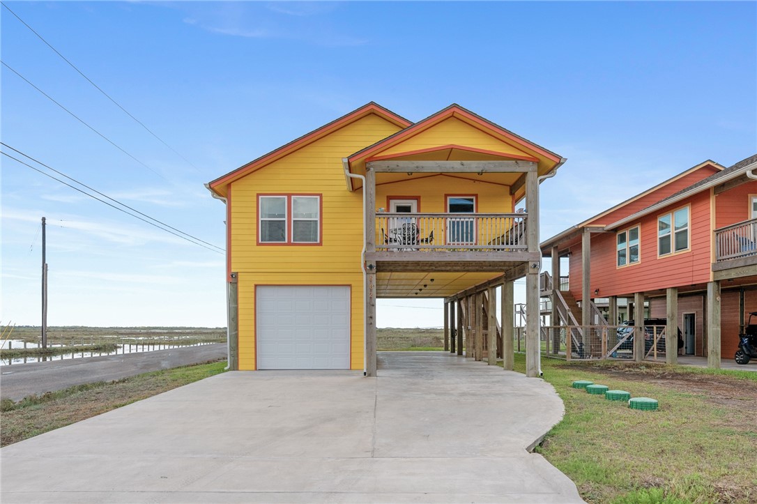 Here is the adorable beach cottage you have been looking for! This 2 bedroom/2 bathroom home is on a corner lot and is immaculate, with an open floor plan, granite counters, huge island, owner's suite, water views from every window, and wood look flooring throughout. You can enjoy your morning coffee with a view of  the Copano Bay Bridge off of the back deck! You will also have a large garage for your boat or fishing equipment and additional covered parking under the stilt home. This home comes fully furnished with beachy decor, so all you need to bring is your bathing suit! This is the ultimate find and would make a great vacation rental, investment property, or permanent home.  The community boat ramp is across the street, the kayak launch is around the corner, and there is a wildlife nature preserve beside the home.  There is also a community pool and a pier in the neighborhood.  This is the most peaceful, serene location with beautiful sunsets and abundant wildlife all around!