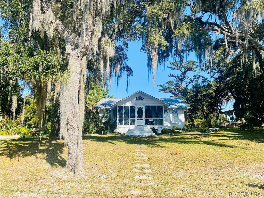 What a rare opportunity to own this Cracker style home on the Steinhatchee River with your own private dock and dock house! The House on the Hill was once considered a storm safe haven because it is on one of the highest locations on the island and has withstood all the storms since it was built in 1946. This cracker style gem has been renovated to fit the modern lifestyle but leaving the Old Florida charm. The home is well situated on almost an acre of land with three paved streets. There are two RV hookups with water, sewer and electric. There is plenty of room for boat trailer parking. The interior features 3 bedrooms and 1 bath, large kitchen and tile floor throughout. Step outside to the covered porch and head down to the river to your dock and boat cabin. The water rights extend all the way to the center on the river. You can be from the dock to the Gulf in about 20 minutes, all deep water. The cabin has a kitchenette and bathroom with a porch that leads the dock. Enough room for 2 to sleep comfortably. Close to the marina, community center, playground, restaurants and local shops.