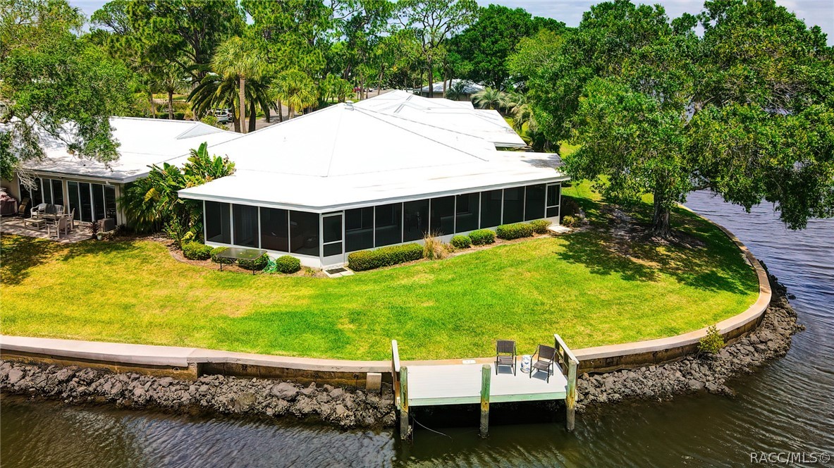 ONE OF A KIND VILLA WITH A DOCK ON THE DEEP WATER CANAL! This was the builders unit & is the only floor plan like it. Built on a bend on the river you have unlimited sawgrass views and the BEST sunrises & sunsets. There are 2 master suites, a wood burning fireplace, a HUGE living area and a screened in back porch that wraps around the back of the unit overlooking the water. Hot tub included! The Islands community offers a clubhouse, tennis court and a heated pool. This one is priced to sell, don't wait, call now for a showing!