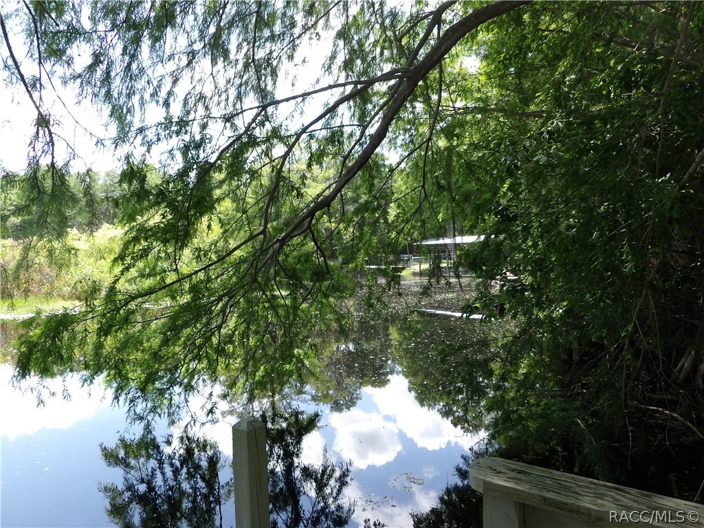 Long and winding road that leads you home. This waterfront home has a new roof. Freshly painted interior and exterior, new decking on porch, tiled throughout home. 
Completely fenced with gates at front, except dock area. This one is a must see