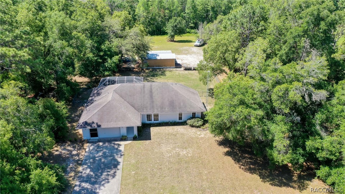 LOOKING FOR PRIVACY, ACREAGE, NO HOA OR RESTRICTIONS,  BUT STILL ONLY 5 MINUTES TO DOWNTOWN CRYSTAL RIVER? HERE YOU GO!!! THIS CONCRETE BLOCK 3/2/2 CAGED POOL HOME, SITS ON 5 ACRES (MOL) TOGETHER WITH A 21X28 DETACHED WORKSHOP.  Tile floors in the open concept living area, with lots of counterspace and storage in the kitchen! Split plan; Sunroom/Family room; Spacious back porch overlooks the Caged concrete swimming pool & waterfall; The house sits back from the road, offering a long paved drive; Enjoy your morning coffee or evening cocktail in your private backyard and watch the deer & rabbits pass through! New pool pump; This home includes the extra lot; Home being sold "AS IS" with buyers right of inspection. Shown by Appointment only...24 hour notice please.