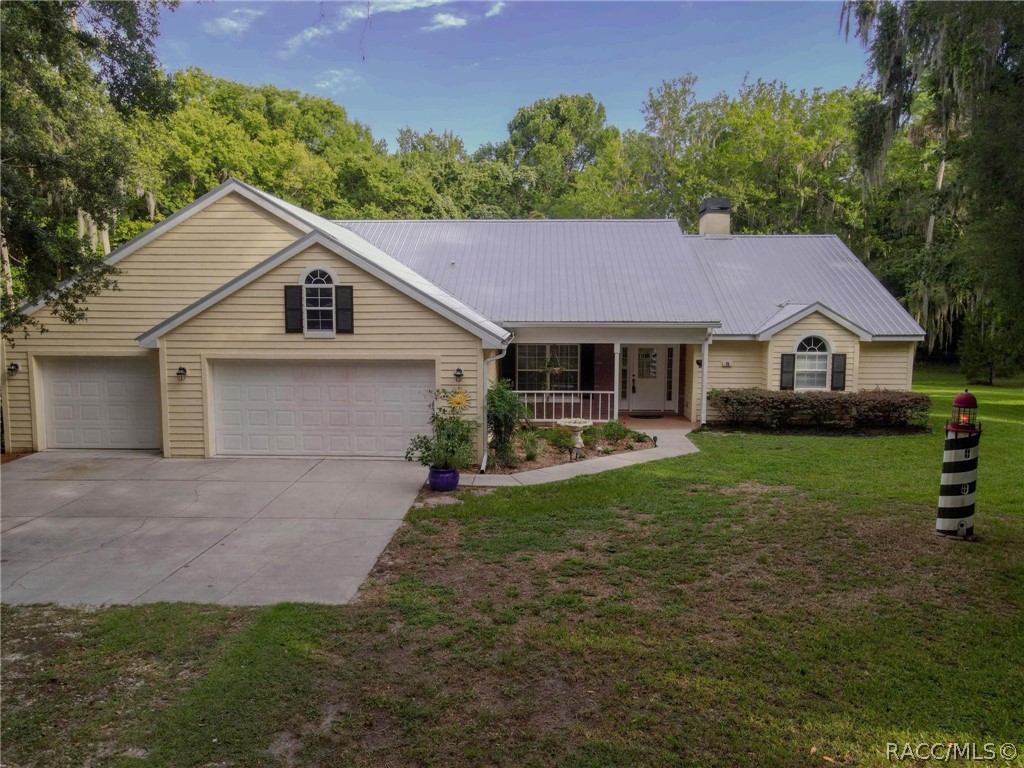 "Serenity" describes this meticulous Sweetwater 3/2/2.5 home on 1.58 acres with 300 feet of waterfront canal. The canal leads to the Withlacoochee River, which leads to the Gulf of Mexico. The living room offers sliding pocket doors to the Veranda for you to enjoy the park like setting in your own back yard. There is a lovely fireplace for the cool days with unique wood shelving on either side of the special mantel. This kitchen will bring you back many times for the pleasure of baking and preparing your meals! One of a kind design tiles over the kitchen stove are just part of the beauty of this home. The master bedroom is large and spacious with a walk in closet and pocket sliders to the Veranda too. The master bathroom has a bench to sit on while in the shower, dual sinks and plenty of storage. There is a vacant parcel that joins this homestead that could be separated to build another home or work barn. This parcel use to have a home on it, so the city water is already there. It has a large carport cover for storing boats, RV's  or cars. There is another parcel just across the street that .36 of an acre included in this sale.