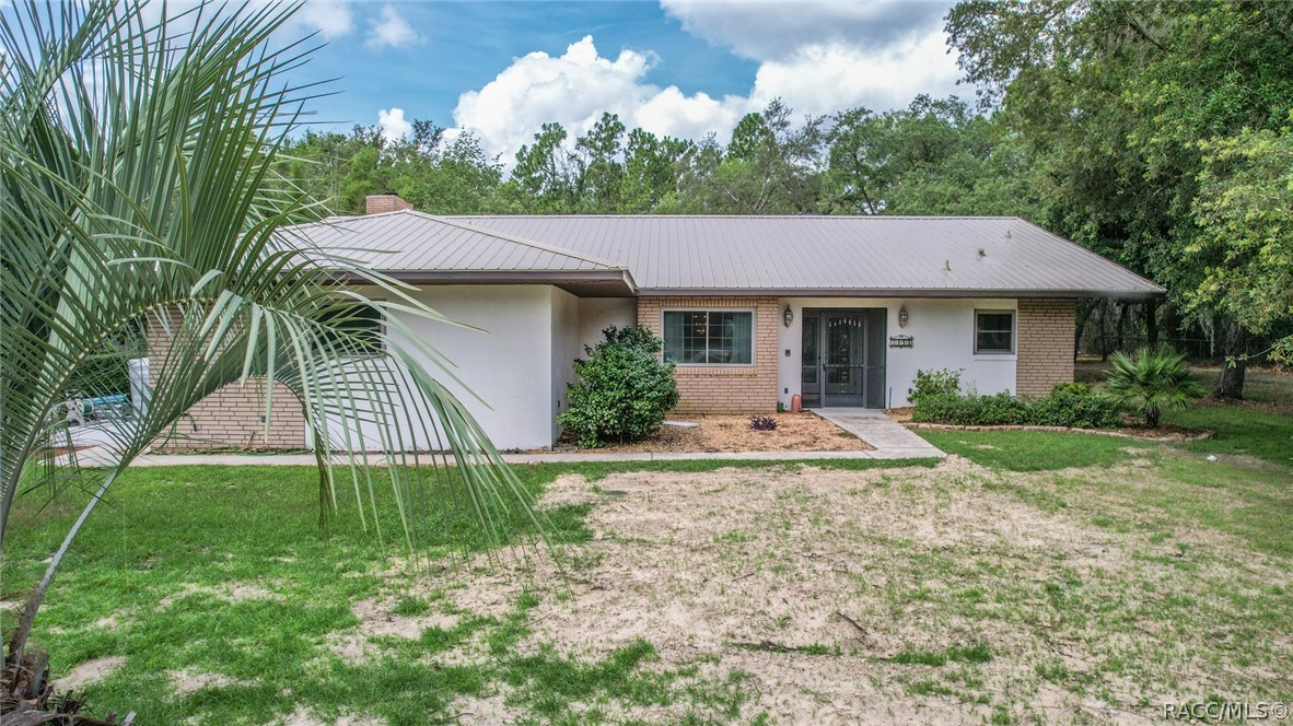 Nice Pine Ridge home has many recent improvements. Home received a steel roof 6/21. New flooring in family room and guest rooms. A/C replaced in 2018 and newer windows added in 2015. Also added was a 18 X 35 carport with a 15 X 18 shed. Home also has a new drain field 6/22. Home has cathedral ceilings with a formal living and dining room and a family room. There's a fireplace taking center stage and also built in shelves with lower cabinets. Family room also has receptacles in the floor for plugging in lamps which is very convenient. There are two sky light in the home one in family room and formal living room. Gives natural light through out the day and on nights with a full moon. Very comfortable home. Kitchen has new stainless stove less than 6 mo. old. and large pantry. Kitchen has a counter bar area that opens up to the family room. Breakfast area also next to kitchen. Sliders to lanai from breakfast/kitchen area, formal living room and Master bedroom. Home has a split floor plan with the master bedroom located off formal living room with lots of extra space for a separate seating area also has a nice walk in closet. Master bath spacious with double sinks, shower and tub. Lanai is spacious with carpet under room and a large screen room for plants and sitting outdoors. Home has a large laundry area with more storage shelves or consider it  extra pantry area.  Home sits on 1.14 acres. Garage is an oversized 2 car with built in cabinets for storage and a utility sink.