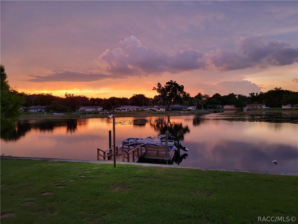 Updated waterfront property on the Tsala Apopka Chain of Lakes!! Your dream homes awaits with views of the lake in every room across the back of the home!! In 2018 this home was remodeled with a NEW kitchen with wood cabinets, granite countertops and stainless appliances, NEW vinyl flooring in living areas and NEW carpet in bedrooms, all 3 baths are updated, NEW windows and NEW interior and exterior doors, NEW ceiling fans and light fixtures, plus the heat pump was replaced!! In 2021, it got a NEW roof, New ductwork in the attic, extra insulation was added to the whole attic, and NEW GarageTrak Diamond Interlocking flooring was put in the garage. In 2022, the driveway was widened and replaced with pavers, and the kitchen was enlarged by adding another section of cabinets. Come take a look before it's gone!!