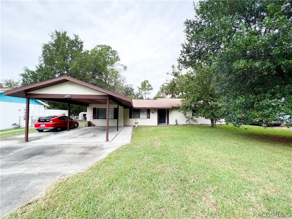 If convenient location is what you're looking for, then this home is it!  3/2 split floor plan located down a quiet street on .25 acres.   Walk in to tiled floor for that cool Florida feel. Close drive to Three Sister's Springs and just a short drive to Homossassa, Inverness and Lecanto.  This home is right around the corner from groceries, dining and shopping.  Slide open the glass door and enjoy your coffee on the screened-in back porch while you watch your pet or children play in the fenced in back yard.  Additional storage is supplied with a shed.  Concrete drive with covered carport for parking.