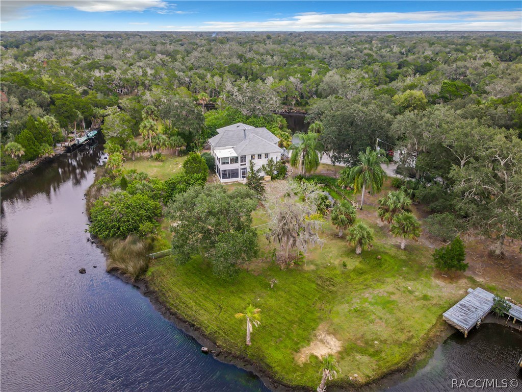 Old Homosassa retreat. Nestled on 2.50 on Mason Creek giving you direct access to the Homosassa River and Gulf of Mexico. Inside this 2 story beauty you'll find a wood burning fireplace, vaulted ceilings, windows every time you turn with new blinds. Newly installed tankless water heater, washer/ dryer, roof in 2018 and HVAC in 2021. On the first level is a mother in law suite with full kitchen, private bedroom, plenty of storage, full bathroom and two entrances from the garage or patio. Easy access from the 1st floor to the second with your own elevator. Partially fenced yard and doggy doors throughout the home giving easy access to Foo Foo or Fido. Outside is a large pond feed by the river. Two docks. Plenty of room to start a garden or keep your boat trailers and kayaks. A full sprinkler system with the option to use the water from the river. Great location to boat ramps, local waterfront restaurants like the Monkey Bar and the Freezer. Golf cart friendly community. There is also the potential make make this a lucrative AirBnb or VRBO.
