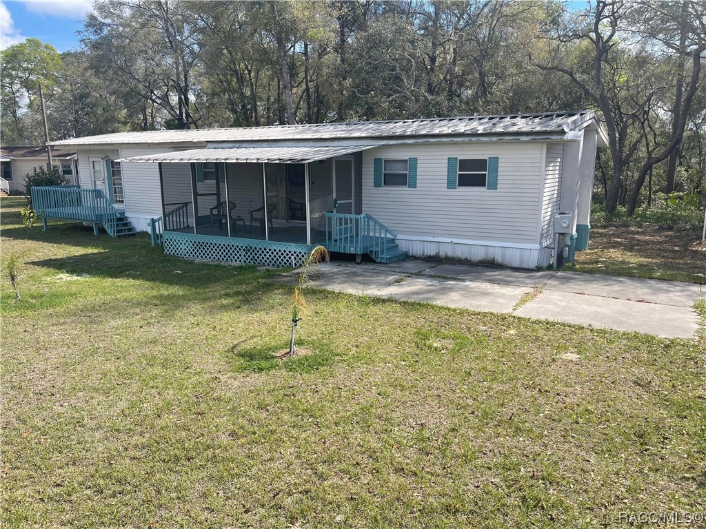 Sought after Magnolia Lake Estates! Curving roads and homes with mostly 1+ acres. Spread out in a country like atmosphere, yet only minutes' drive to downtown Inverness. Fully furnished Move-in ready Double wide mobile home with large 12 x 22 bonus room which with added closet could become a spacious third bedroom, or just keep as is for a comfortable Florida room. Two wooden decks one with screen. Large bedrooms two full baths and walk-in closets. Generous concrete driveway up to home and large utility/workshop with laundry, washer and dryer included. All of this on one acre!