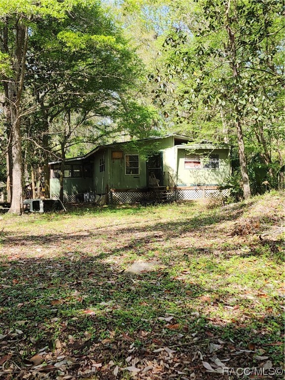 Just off US 19, take a drive through the canopy tree lined street to this almost 3 acre property with well and septic and power pole.  Home is not inhabitable and needs to come out, however seller is leaving it for new build purposes.