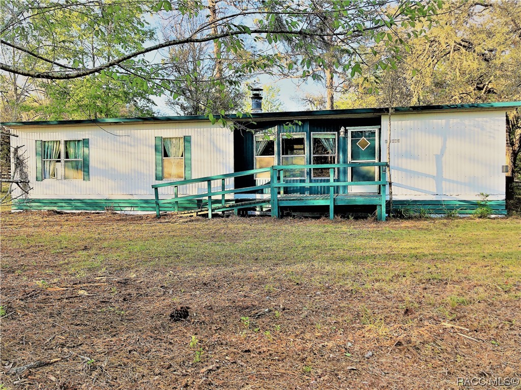 COUNTRY LIVING AT ITS BEST.ZONED A1 BRING YOUR HORSES BOAT RV& TOYS. IMAGINE MORNING COFFEE ON YOUR FRONT STEPS WATCHING A GOLDEN SUN RISE OVER TOWERING PINES. FRONT 3 SIDED BAY WINDOW LOOKS OUT ACROSS THE PAVED STREET TO NEIGHBORS CLEARED ACRES LINED BY BEAUTIFUL MATURE OAKS & PINES. YOUR .95 ACRE IS CROSS FENCED WITH ITS OWN CATTLE GATED ENTRANCE AT ABOUT 55% OF THE GROUNDS TO ALLOW PRIVACY AND SEPARATION IF YOU CHOOSE TO PULL IN A NEW MOBILE OR BUILD YOUR DREAM HOME OR A NICE OUTBUILDING GARAGE/WORKSHOP. NEWLY UPDATED WELL CAN ACCOMODATE BOTH.3 STORAGE SHEDS CONVEY WITH SALE. YOUR DOUBLEWIDE HAS NEW CARPET IN ALL ROOMS BUT BATHS & OFFICE. BOASTING 2 BED 2 BATH WITH OFFICE & INSIDE LAUNDRY WITH PRIVATE REAR ENTRANCE. HOME HAS A REAR SCREENED PATIO & DECK TO ALLOW FOR EVENINGS OVERLOOKING YOUR CRACKLIN'FIREPIT THAT ROASTS THE EVENING SUPPER, AS THE BLOOD-ORANGE SUNSETS WARMLY ILLUMINATE THE BIG WESTERN SKY VIEW. RV HOOKUP POWER SUPPLY, SEPTIC PORT & WATER ARE ALONG WESTSIDE OF HOME AND HAVE ANOTHER SEPARATE ENTRANCE FROM THE PAVED 95TH ST SIDE. 130 AVE ON EASTSIDE HAS PRIVATE ENTRANCE. COME SEE WHY DUNNELLON IS THE UNDISCOVERED JEWELL & "BEST KEPT SECRETS OF COMMUNITIES" IN N.CENTRAL FLORIDA.COME HOME TO SECURE SERENINTY AND WIDE OPEN SPACES OF WEST MARION COUNTY. TO YOUR CENTRALLY LOCATED "RIVER AND OUTDOOR LIFESTYLE HOME" DON'T MISS IT! LOCAL SHOPPING DINING AND DOCTORS. ALL THE CITY CONVENIENCES ONLY A 20 MINUTE DRIVE TO OCALA JUST 30 MINUTES TO CRYSTAL RIVER OR INGLIS/YANKEETOWN FOR GULF OF MEXICO ACCESS,DUNNELLON HAS 3 STATE PARKS ON THE CRYSTAL CLEAR RAINBOW RIVER.TOTAL OF 2 RIVERS & LAKE ROUSSEAU IS A 15-20 MINUTES FROM YOUR NEW HOME.CEDAR KEY BEACH 1 HR​​‌​​​​‌​​‌‌​‌‌‌​​‌‌​‌‌‌​​‌‌​‌‌‌ AWAY.
