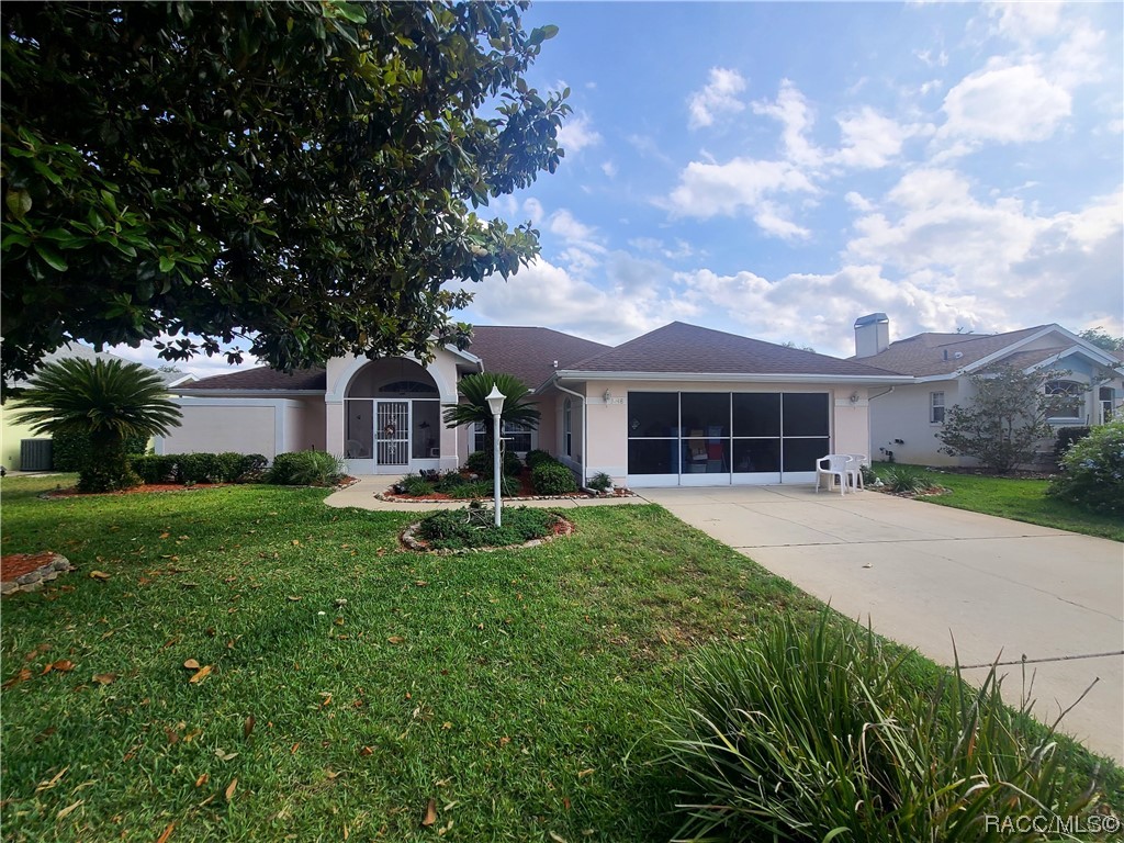 Located in the beautiful water adjacent 55+ Community of Arbor Lakes. This spacious extended Sanibel model home boasts a large open floor plan and cathedral style ceilings. With an enclosed Florida room, one can open both sets of sliding doors for another climate controlled bonus room; perfect for hosting guests or just a little more "floor space". The beautiful eat-in kitchen with breakfast bar is perfectly settled in the heart of the home. With a walkway right through the kitchen one can go from one side of the home to the other, pretty much without walking through any additional rooms. With beautiful curb appeal this home conceals one's garage interior even with the door open, with its full sliding screen doors across the garage. The oversized enclosed front porch is perfect for just wanting to enjoy being able to see the lake and read a book. Everything about this home shouts "welcome home". Just stepping into the double french style front doors puts you right next to the spacious Master Bedroom with it's own private door to the fully enclosed Florida room as well as the Master Bath featuring a large garden tub;perfect for soaking and separate stand up shower and separate enclosed Lavatory closet for more privacy.