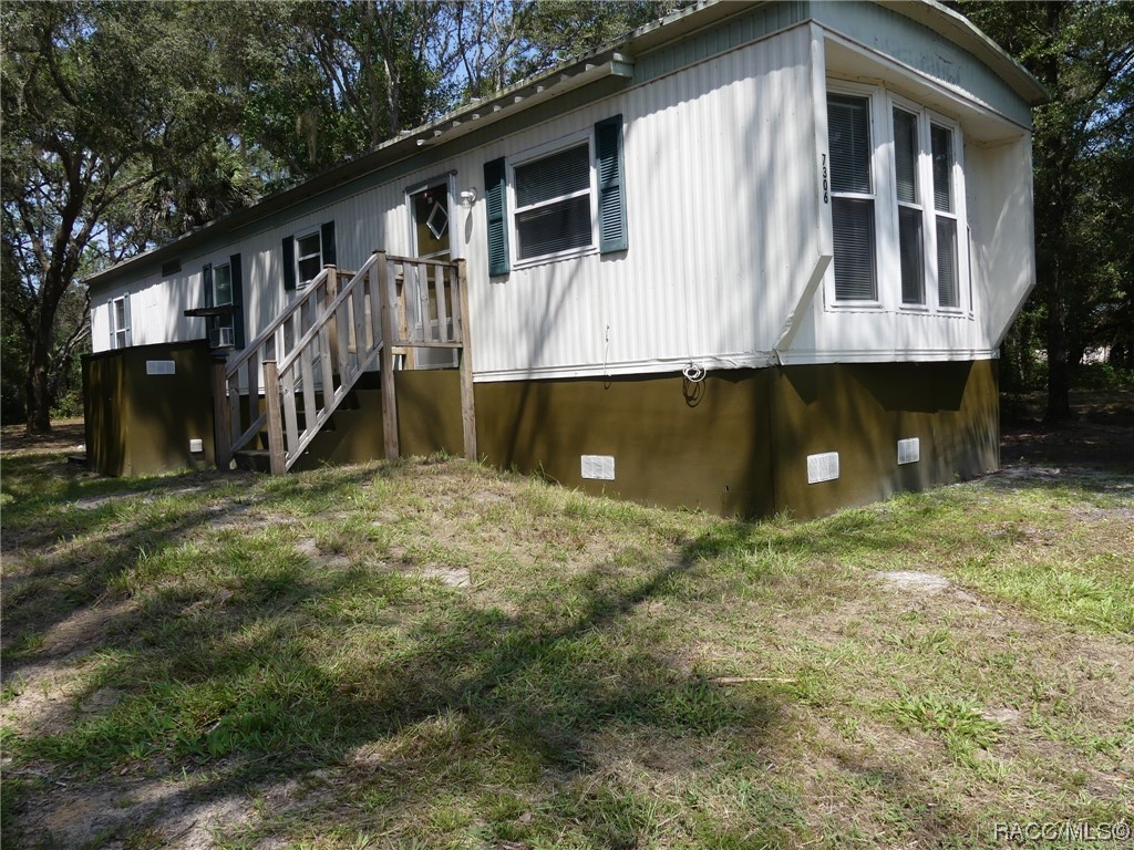 This Mobile Home is located out in the country north of town off Dunnellon Road.  The well and oversized septic system were installed in 2019 along with a new electrical service drop and interior electrical panel.  All plumbing piping was replaced with new pvc this month and the windows were replaced with new dual pane windows also. Very country setting at the intersection of N Nathan Point and Blue Rock Court.  The existing lot currently is 2.03 acres and includes 7338 N Nathan Point (main address) but will be divided legally at closing by the Seller and new address has been established with Post Office.  There is also a washer and dryer shed installed adjacent to the mobile home with new water connections and electrical lines.  The sturdy metal roof has been painted with two coats of elastomeric roof sealant this past week. If you are looking for a solid mobile home that is affordable and has an acre of country this could be the place for you.