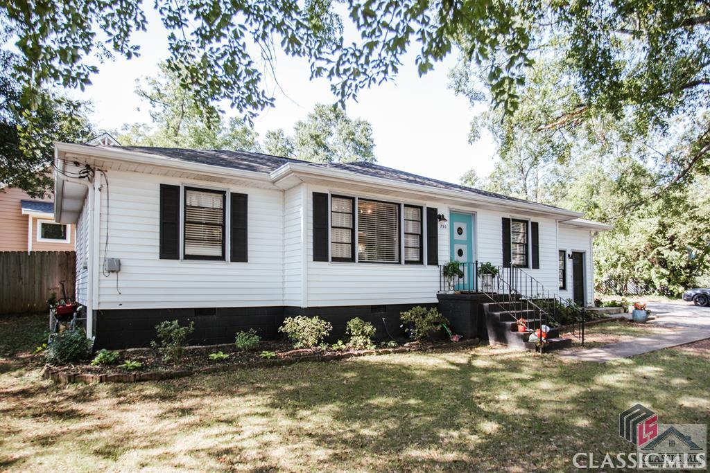 Custom, remodeled home in the highly desirable General Hospital neighborhood. Perfectly sited on a .34 acre corner lot and located 2 minutes from downtown/UGA and within walking distance to some of Athens famous eateries, Athens Regional & the new UGA-GRU Health Science Campus. This 3 bedroom, 2 bath home boasts many fine appointments including gorgeous hardwood flooring, penny tile, new interior doors & hardware throughout, custom decorative light fixtures, and updated decorator paint colors. This reconditioned ranch features an open floor plan boasting multiple living spaces, large dining area, enormous kitchen, and laundry room. Entertaining is made easy with the large great room and second living space in the sunken family room, both located off the kitchen. The jewel of this home is the unique designer kitchen featuring modern finishes to include silestone countertops with a long peninsula with bar seating, custom glass tile backsplash, and an abundance of custom cabinetry with glass fronts and backlighting. Located just off the kitchen is the first bedroom with the other two perfectly located down the left hall. Each spacious bedroom is complete with hardwood flooring, ceiling fan light fixtures & closets with shelving systems. The renovated hall bath features tile floors, pedestal sink, and shower/tub combo with reglazed tile surround. A young HVAC and roof are great benefits to this home, as well as the newly added full bath and laundry room with a sliding barn door.  The outdoor spaces include a covered front entry porch, private rear patio & yard encased with a privacy fence.  This immaculate home must be seen to truly capture its charm and functional floor plan! The ideal in-town location and wonderful condition with modern amenities makes this an unbeatable value!