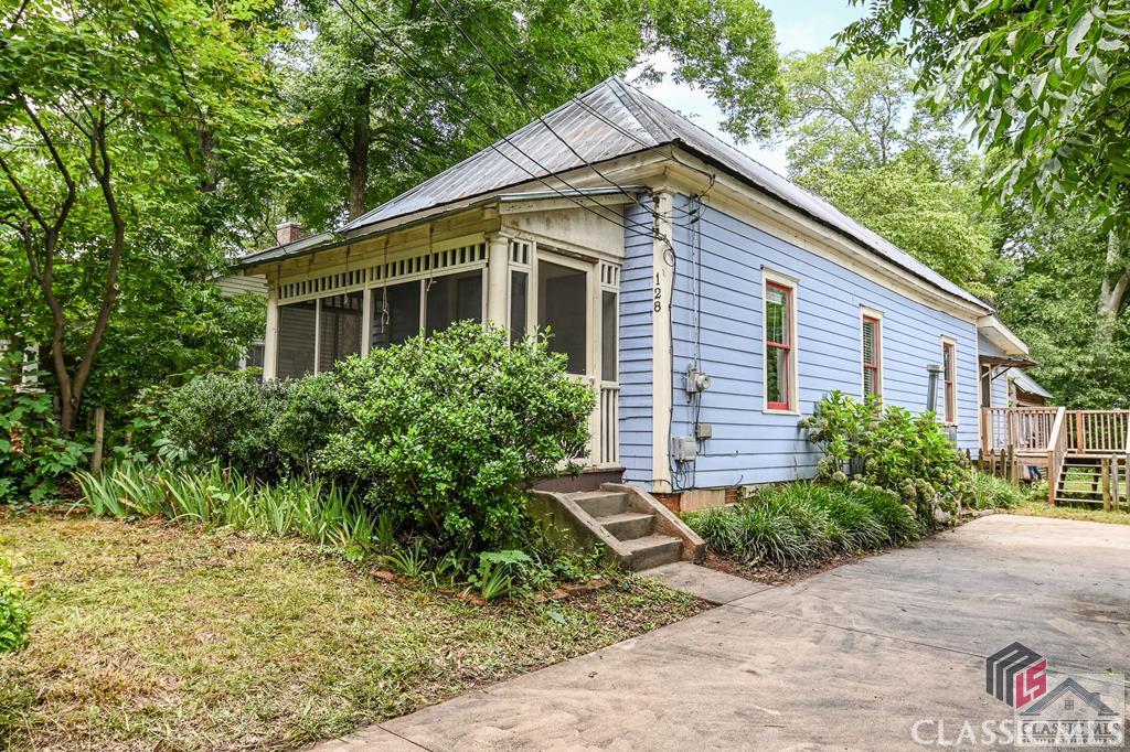 Don't miss this great opportunity to buy in one of Athens' favorite neighborhoods - the Historic Boulevard District! 128 Nantahala Ext is a circa 1918 cottage with lots of potential. Make it your own or add it to your investment property portfolio. Tucked away just off of Boulevard and walkable to Normaltown restaurants / bars / coffee shops, this “shotgun” style house is charming from the screened front porch to the rustic workshop. Inside the home, take note of the original hardwood floors, plaster walls, decorative old coal burning fireplaces and wainscoting. The kitchen offers plenty of room to cook (yes, it's a gas stove) and hang out. At the back of the house is a large bedroom with great natural light and bamboo flooring, a full bathroom and a laundry room/mud room which leads out onto a wood deck. The fully fenced backyard hosts mature trees and plants and features a beautiful workshop with power built in 2005. You absolutely do not want to wait to see this one! Schedule a showing today.