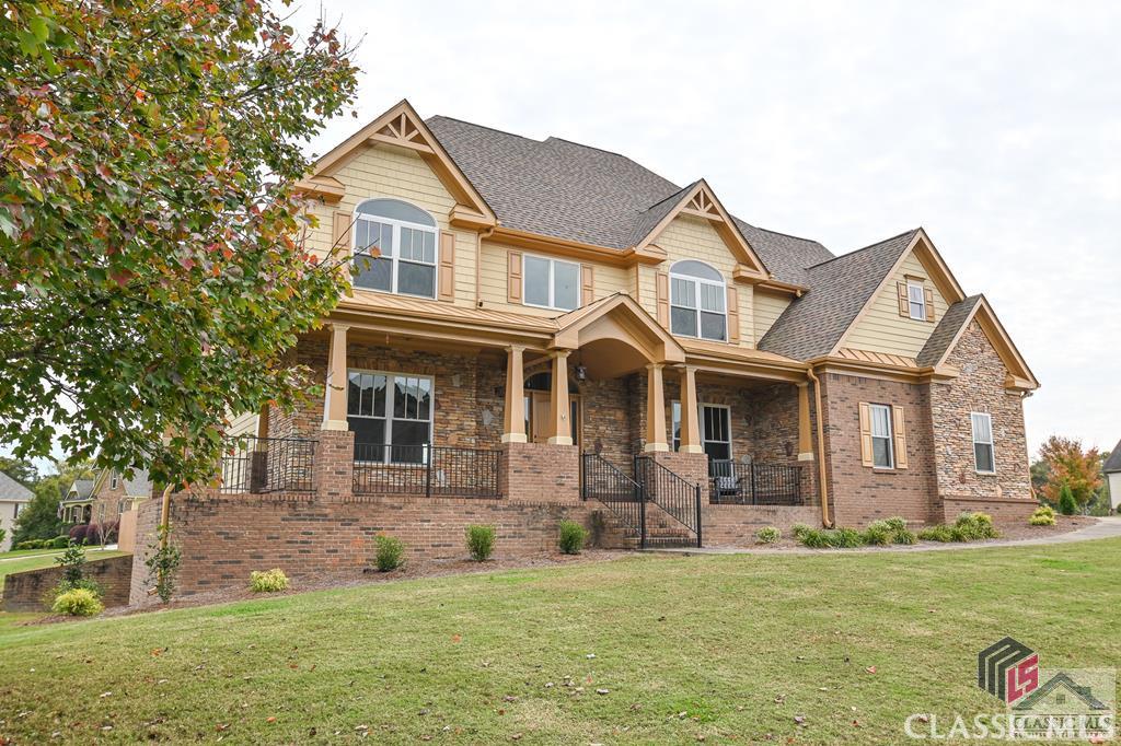 Located in the highly sought-after North Oconee School district is the Rambling Rill neighborhood. This 5-bedroom/ 4 bath offers hardwood floors throughout most of the main level, a large dining room, foyer, and a guest room. The natural light highlights a floor-to-ceiling stone fireplace in the living room. The kitchen includes an island, granite countertops, and easy access to the lower deck overlooking the backyard. There are lots of windows across the back of the house that overlooks the flat backyard. The Owner's Suite upstairs is tucked away with lots of privacy featuring a large tray ceiling, a sitting area, and windows overlooking the backyard. The Owner's Suite bath includes a large walk-in shower, jetted tub, and one large walk-in closet along with another full-sized closet. There is a door from the Owner's Suite that leads to a private deck sitting area with a view of the pond. New interior and exterior paint. Refreshed hardwoods downstairs and new carpet upstairs. The roof was replaced two years ago and the hot water heater was replaced one year ago. Want to build equity? The stubbed unfinished basement is a perfect way to expand living space.