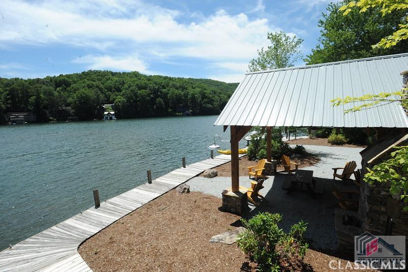 Private Lake Burton access community. Enjoy paved access to the fee simple 3+ acre buildable lot with a designated boat slip at a shared dock on Lake Burton. The shared lakefront common area features a pavilion with outdoor fireplace. Don't miss this affordable opportunity to own on Lake Burton!