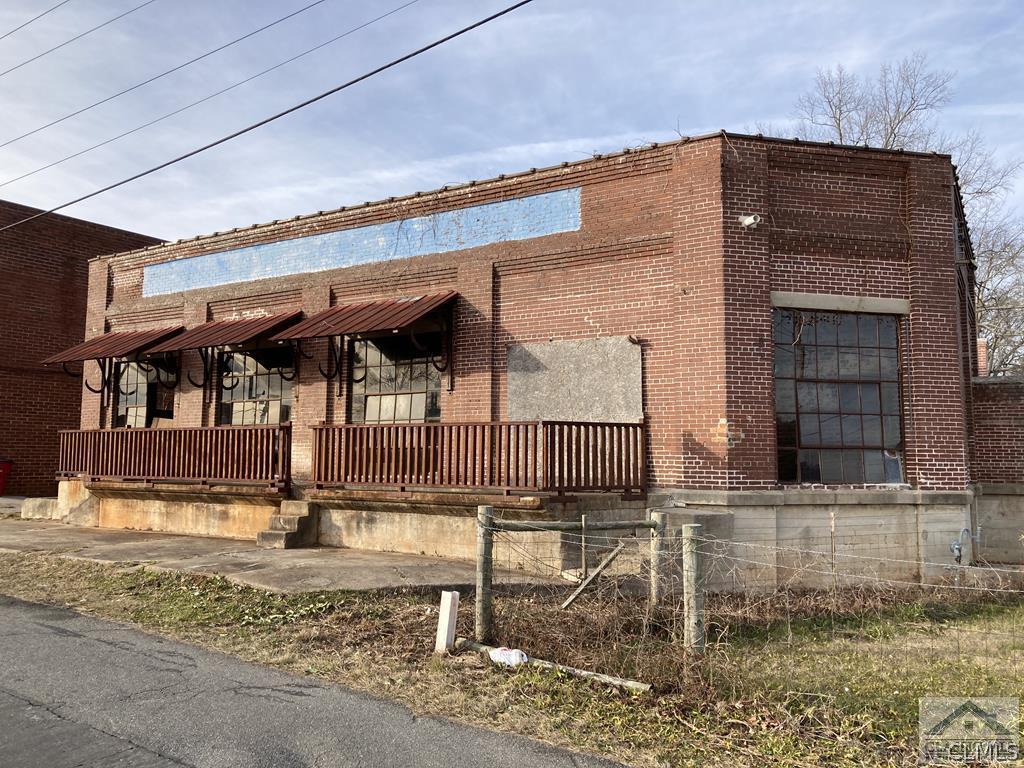 Unique Opportunity to own a piece of historic Georgia in small town Sandersville. Two properties, the original Ice House & its original Power House. Built in 1923, the Ice House was Sandersville's first and only ice production plant. The city constructed the Electric Light Plant and Pump House (Power House) circa 1905 to serve the City of Sandersville, its businesses and residents with electricity. Seller will consider - Build to Suit or Lease/Purchase. Both parcels must convey together. City of Sandersville has been very supportive of the preservation of the site. Ice House is registered historic and facade cannot be changed, other 3 sides can be adjusted. Power house is not deemed historic and can be demolished or changed. If built out as restaurant, Ice House would be 2,700–3,200 square feet on 0.52 acres. Power House is 5,200–5,400 square feet on 0.61 acres. Approximately 87-93 guests based on fire code. Estimated rent if finished out is $2,000-$3,000 per month. Seller has almost all equipment to complete build out of coffee shop, including but not limited to tables & chairs, electrical & plumbing fixtures, kitchen fixtures, etc. that could transfer with sale.