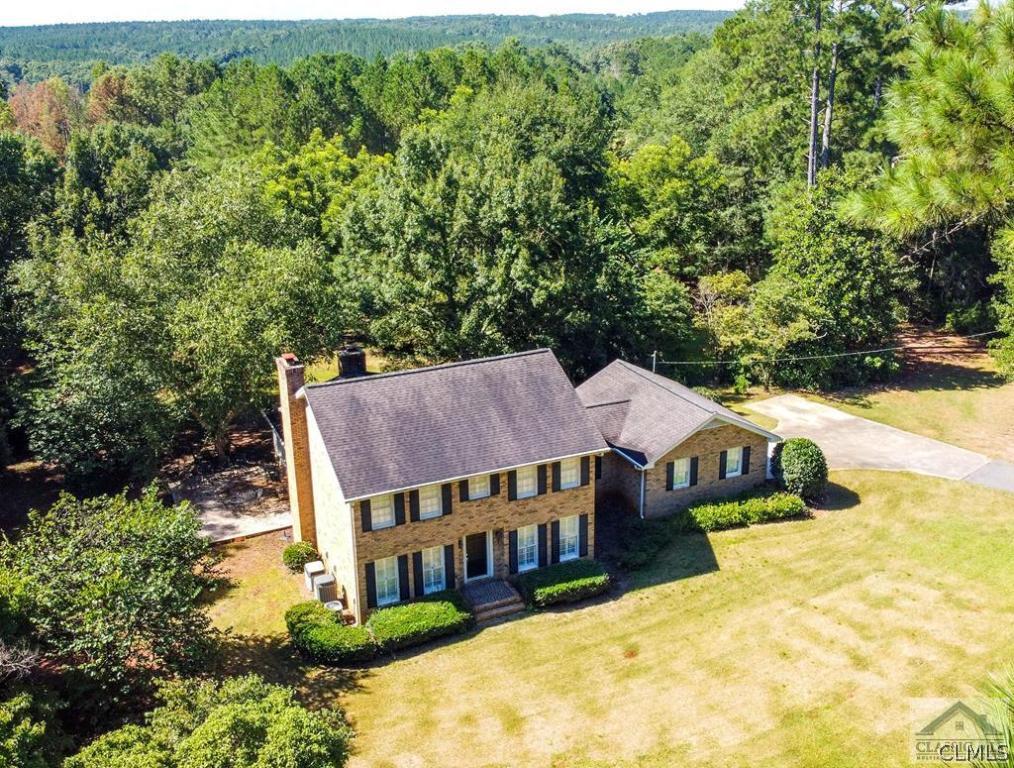 This 4 bedroom, 3.5 bath all brick home has been very well maintained and offers a beautiful sunroom/family room with second fireplace off the back of the home. This traditional/colonial home is located on over 38 acres of mixed hardwoods with open pasture and over 425 feet of river frontage, outbuildings and large garden plot. Enjoy all that nature has to offer while swinging on the grape covered double swing, eating an early dinner on the back deck and enjoying a nature walk to the river. Multiple outbuildings include detached garage/workshop, pole barns for storing farm equipment and more. The property is currently in Conservation.