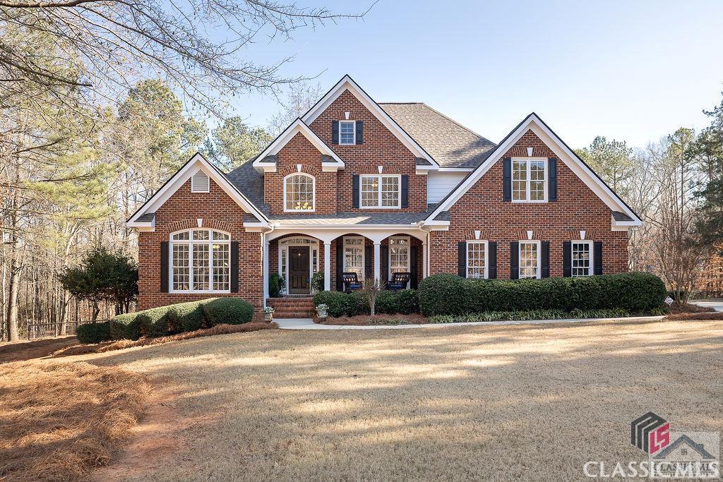 This beautiful, 4 sided brick home is located just minutes from Athens and Downtown Watkinsville! Located in an award winning school system, this Southern Living plan features 5 bedrooms and 4.5 baths and is nestled on a stunning 1.25 acre cul-de-sac lot. The well landscaped and sodded backyard, covered porch and huge rear deck are all great places for entertaining and overlook the large, liner pool.  This home features an open formal dining room, large 2 story family room with an abundance of natural light, wood burning fireplace with gas starter and custom built-ins. The vaulted study is the perfect flex space for either a home office or second living area on the main. The renovated, bright white kitchen features ample storage, hard surface countertops, double wall ovens, walk in pantry, built-in desk with shelves and a large island. Opening to the family room and back deck, the spacious kitchen is perfect for entertaining. The master suite is located on the main level and has a large bathroom with a jetted tub, large walk in shower and double vanity.   The rear staircase leads to three sizable bedrooms, with one bedroom having a renovated en suite bath, and the other two sharing a renovated full, hall bath.  Some additional features include heavy crown molding, hardwood floors, tile flooring and lots of storage space. Downstairs you will find a fantastic terrace level that houses plenty of office space, game room and play space for the whole family. Additionally, there is a built in bar with a full size refridgerator and sink. This home has been lovingly maintained and has too many upgrades to mention. Don't miss out on this amazing property!