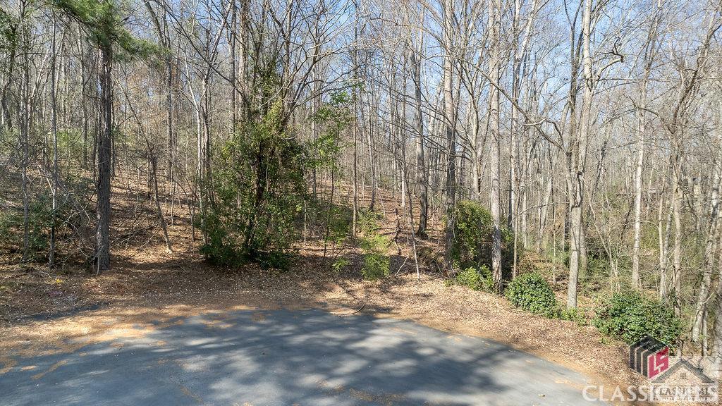Incredibly special building opportunity in Georgian Hills! An original lot retained during the development of the subdivision, this 2.83 acre lot provides a perfect building site in a lovely cul-de-sac in the most convenient location of the Timothy corridor. Surveys completed. ACC water available. Bring your builder and get ready to build your dream home in the woods! Convenient location to Loop 10, the Oconee Connector and Five Points.