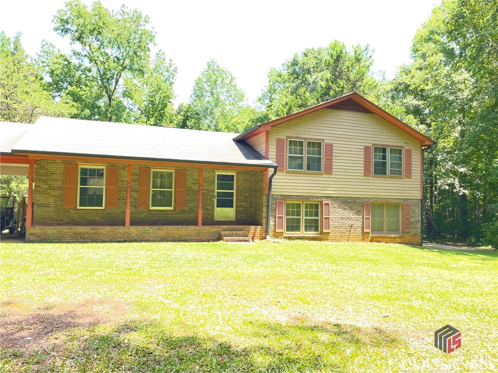 Don't miss out on owning this fabulous home on over 4 acres! Unwind or entertain in the wonderfully secluded backyard that comes with mature trees and a large outdoor deck. Enjoy a prime location in Madison County close to all stores and easy around town travel, but secluded enough to have your privacy. This ideal flexible floor plan concept features a functional interior, and provides well proportioned rooms, generous living spaces, good sized living room, and a wood-burning stove. Find a restful hideaway in the master bedroom that features a private bathroom, or crate a private in-law suite downstairs. The house features original hardwood floors throughout the main floor of the home, and tile flooring in the bathrooms. The house is move in ready, but with some updating, you can have yourself a wonderfully solid home with acerage, for less than $300k! Free appraisal with Preferred Lender!