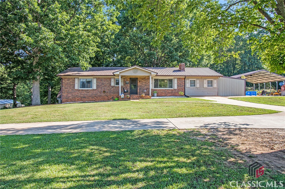 Huge Price drop! Come move to the country. Pull on to the circular driveway of this 1979 well-built four-sided brick ranch with a large basement. The house sits on three acres with a fenced in wooded backyard along with a workshop, chicken coop and goats. The house has 4 bedrooms and 2 bathrooms on the main floor. Two additional rooms can be used as an office and playroom. Large tile floor runs through the main part of the house. A separate entrance to the basement apartment with a kitchen, sitting room and additional bathroom. Lots of storage space is available in this house. Save on heating with a wood burning furnace that heats the whole house also includes a tankless water heater. Two Large Car ports for parking tractor, work vehicle and campers. This home has potential income producing possibility. The basement apartment with a separate private entrance rents for $500.00 month.