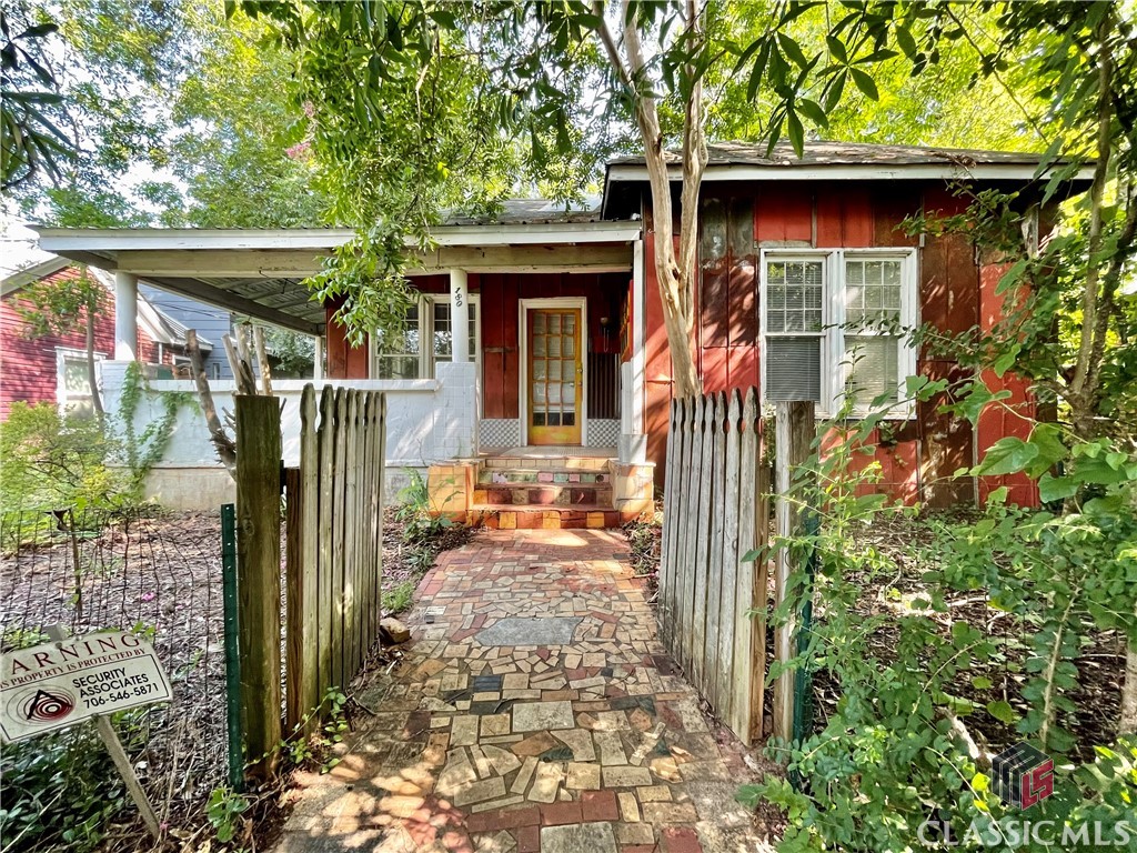 Bring the charm back to this cottage in Lower Cobbham / W Hancock Ave Historic District. Enjoy relaxing on the eclectic tiled wrap-around front porch. Inside features tall ceilings, wood floors, an open and spacious kitchen, and tons of potential to make this place your own. You'll find it hard to beat this in-town location.