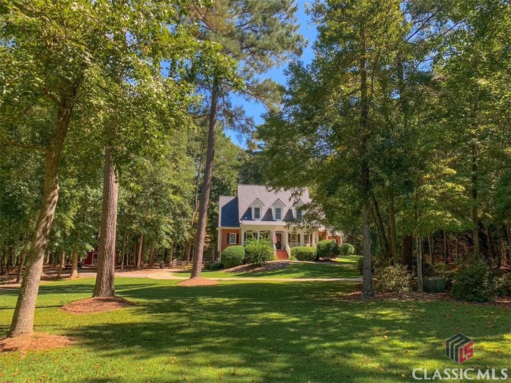 This beautiful custom built 3-sided brick home sits on over 4 acres & includes a finished basement. The main level features an inviting foyer, 2-story family room w/ double-sided fireplace, vaulted ceilings, spacious gourmet kitchen w/ granite counters, stainless steel appliances, tile backsplash, kitchen island, eat-in breakfast area, walk-in pantry, plus a separate dining room. The master suite is on the main level & features a tile shower, whirlpool tub, walk-in closet & double vanities, as well as a cozy fireplace & access onto the covered back porch. An additional bedroom is also on the main level, plus a full bath & the laundry room. Upstairs you will find three additional bedrooms w/ full bathroom, as well as a Jack & Jill bath. The basement offers an additional recreational room & living room/media room, kitchenette area & an additional finished room that could be used as a 6th bedroom, plus a full bath & unfinished space that is perfect for storage. The basement is ideal for an in-law/teen suite. Exterior features include a rocking chair front porch, covered back porch that offers a stacked stone fireplace & an oversized deck that overlooks the fenced backyard that is perfect for entertaining friends and family, as well as a creek that runs along the side of the property. Additional features include hardwood floors, 18x25 detached garage/workshop, new A/C unit, newer 30-year Architectural roof, fresh interior paint & newer carpet. This one owner home has been very well maintained and it shows. Youth/Walnut Grove High School district. The home is conveniently located less than 10 minutes from downtown Monroe, as well as schools, shopping, golf courses & entertainment. No HOA. Buyers will not be disappointed.