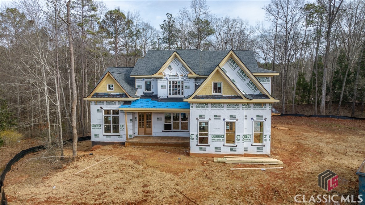 NEW CONSTRUCTION IN OCONEE! This home will truly have it all; location, privacy, excellent craftsmanship and zoned for award winning Oconee County schools! The home will feature 5 bedrooms on a private 1.17 acre lot in a cul-de-sac of Moss Creek. Upon entering the 2-story foyer, you will find an expansive dining room to the right and private library/office to the left. Continuing straight ahead, enter the expansive grand room with a fireplace. A covered porch will be just outside; the perfect place for morning coffee and southern evenings. On the right side of the home, there will be a 3-car garage, mud room and drop area, full laundry room, and half bath. Just beyond this in the center and back right will be the gorgeous kitchen, complete with working island, breakfast area and family room with its own fireplace! The owner's suite is planned to be center and back left of the home. It will have its own access to the covered back porch and a beautiful en suite with double vanity, tub, separate shower, and generous walk-in closet! Upstairs, there are 4 bedrooms and 4 bathrooms planned along with a separate media room! There will be a full unfinished basement. From this location, it is 5 miles to the Oconee Connector/Hwy. 316, 3 miles to Watkinsville, and 8 miles to the UGA. Don't miss this opportunity! Call Tracie today for further details, updates and copies of plans!