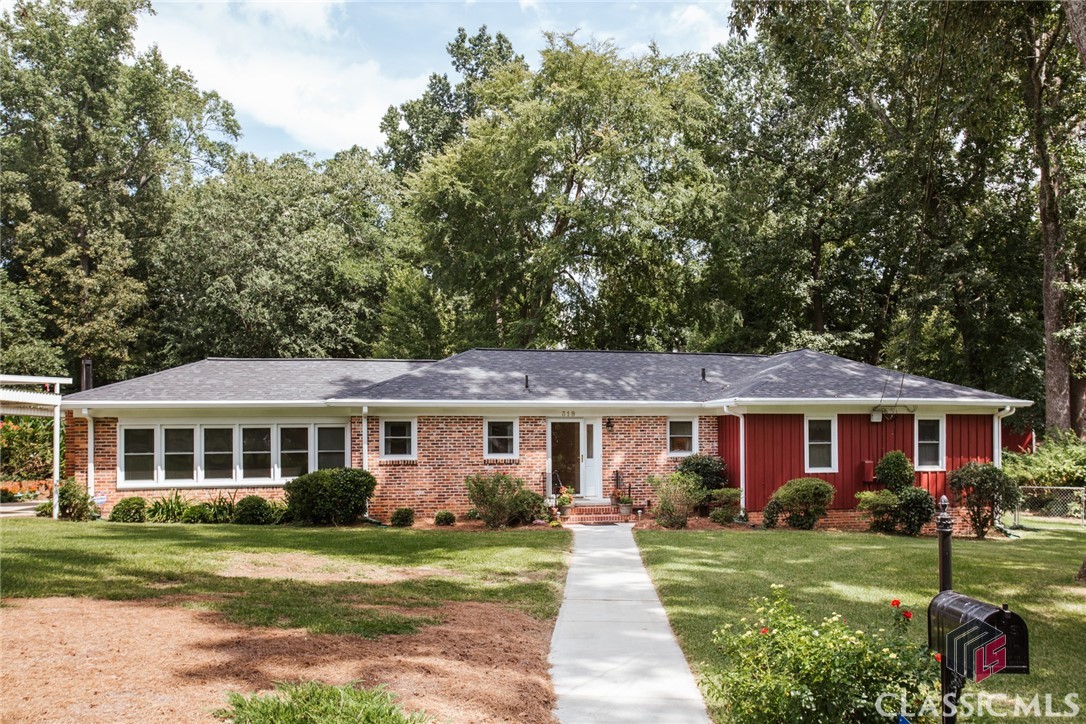 If you've been looking for a place to customize and call home in Five Points, then 319 Parkway Dr is the one for you. Tucked away in a quiet neighborhood, this single-level brick ranch is tucked away in a quiet neighborhood on 0.47 acres. The yard's green space and colorful flowers attract butterflies and pollinators year round. A private back deck and brick patio is the perfect spot to enjoy morning coffee from Jittery Joe's or unwind at the end of the day with a good book from Avid Bookshop. Stepping inside, you'll be pleased with the layout and extra flex spaces this home has available. The sunroom, which sits just off the eat-in kitchen, features a wall of windows (hello sunshine!) and a gas log fireplace with remote starter (hello sweater weather!). Adjacent to the living room is a den with deck access ideal for a home office or craft room. A central hallway leads you to the home's three bedrooms and two bathrooms. The primary bedroom has been expanded to add a private bathroom, large walk-in closet and a flex room to use as you wish. Located in one of Athens' most desirable and walkable neighborhoods. Minutes to The University of Georgia and some of Athens' favorite restaurants, bakery, coffee shops, chocolatier, grocery store, bike shop +more. Call your favorite Athens agent to schedule an appointment to view 319 Parkway Drive.