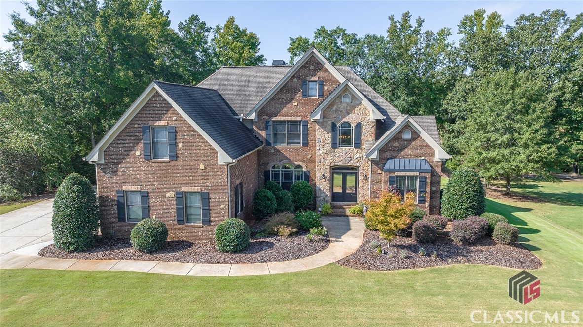 This oasis should not be missed! Located in Somerset subdivision, this beauty boasts 5 bedrooms, 5 1/2 baths on a finished basement with a gorgeous pool!  Perfectly located in the North Oconee district, it has quick access to Highways 78 and 316 to Athens and Atlanta. Inside the front entry, the two-story foyer greets and sets the standard with a light and airy feeling. To the right is an office that overlooks the front yard and can be closed off with french doors. To the left is the expansive dining room, also overlooking the front, with fresh paint and a beautifully custom papered ceiling. Just beyond is the great room with so many windows to bring in an abundance of natural light. Do NOT miss the spectacular center light fixture! To the left of the home is the kitchen with stainless appliances, including gas cooktop. Sons of Sawdust reclaimed wood tops lend a true custom touch! A breakfast nook is to the left. Overlooking the kitchen is the keeping room with another fireplace and custom window benches on each side and another fantastic chandelier! Just behind the kitchen, and tucked away, is the owner's entrance with pantry, laundry and cubbies for dropping everyday stuff. On the right side of the main floor is the owner's suite. The papered back wall creates a focal point. The en suite has separate shower, tub, toilet and large closet. Upstairs, the hardwood hall will lead you to three bedrooms, each with their own bath. There is plenty of space and storage! In the basement, the owner's have two bedrooms and one full bath with oversized shower. In the middle is the den large enough to host large gatherings! On the other side of this, there is storage space and a workshop with garage door. Part of this space would be the perfect area to add a kitchen for an in-law suite or just an addition. Outside the basement den doors is the highlight of the outdoors; the amazing pool and hot tub! This pool was just added in 2018, is salt water, features a water fall and heats!! The black iron fence around and custom steps and pathway truly give this area a resort feel. In the beautifully landscaped yard, you will also find a fire pit area at the very back overlooking the picturesque pecan orchard! Peaceful is an understatement! The home will be open to show starting Saturday, 9/24. Call today for further details!