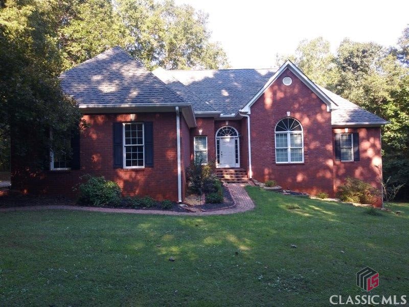 Welcome home to the privacy and enjoyment of a house located in a beautiful Oconee County subdivision. The attractive minimal care brick home is surrounded by 5+ acres of hardwoods and nature. The neighborhood provides a pleasant environment for walking and jogging. The lovely interior is an inviting 2612 sq. ft. 3 Bedroom 2 and 1/2 bath home with an additional 2612 sq. ft. lower level for expanding to a total of 5224 sq. ft. It features a beautiful kitchen with granite counter tops, built in dual oven/microwave and large pantry. The breakfast area opens to an outside view for a relaxing morning coffee. Graceful high ceilings accent an attractive foyer, formal dinning room, and living room. The bedrooms are spacious with large walk-in closets or dual closets. The primary bedroom is oversized with a sitting room accented with a decorative fireplace. A well placed office or craft room is located off the main bedroom. The deck is perfect for cookouts with a picturesque view of sweeping greenspace. This home is located 10 minutes from the University of Georgia and is conveniently located to the local K-12 schools in Oconee County, Georgia.