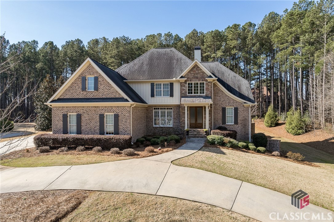 Located in the North Oconee School district is Meridian, one of Oconee's most desired swim/tennis communities. This well maintained 5 bedroom/4 bath custom home built by Rodney Jones includes a finished basement,  owner's suite on the main level, site finished hardwood floors throughout main level living area and an additional bedroom/study on main. The vaulted great room offers open living space highlighted by a wall of windows flooding the room with natural light and a stacked stone fireplace spanning from floor to ceiling that is the center piece of the room. The chef's kitchen overlooks the great room with serving bar and includes a large custom pantry, granite countertops, tile backsplash and breakfast area. There is a cozy keeping room with fireplace and stained tongue and groove ceiling located directly off the breakfast room. The Owner's Suite is on the main and is tucked away with lots of privacy featuring a tray ceiling and lots of windows overlooking the back yard. The master bath includes tile walk-in shower with frameless glass shower door, jetted tub, vanity with granite countertops and large walk-in closet. The additional bedroom/study located on the main has an adjacent bath, custom built in cabinet that is sized so that the desk can slide out and be replaced with a double bed.  Upstairs includes 3 additional bedrooms, one with ensuite and the other two share a jack and jill bath. One of the bedrooms upstairs is being utilized a teen suite and features custom built in cabinets and a snack bar. Additionally, there is a built-in desk in the loft area upstairs with two computer stations and plenty of workspace. The walk-out daylight terrace level is mostly finished with media area, flex room, gym, wet bar, and rec room perfect for ping pong or pool table. Updates and extras include exterior painting and HVAC systems serviced in February 2023, synthetic decking with California kitchen, custom trim package, custom cabinetry throughout, walk-in laundry with built in cabinets and laundry sink, pre-wired for speakers throughout and three car garage. This is a fantastic location, only minutes to the schools, shopping, pager range to the hospitals, and easy access to the University of Georgia.