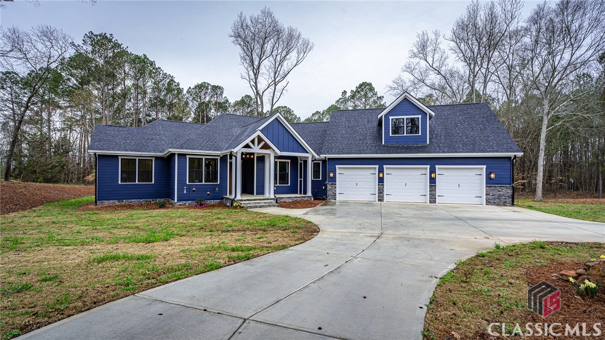 A great opportunity in Oconee County! Located in Bridlegate neighborhood in south Oconee, this ONE STORY home on just over 3 ACRES, was just built one year ago! The details should not be missed, including Pella windows, 10' ceilings throughout, custom cabinetry and lighting, barn doors, luxury plank flooring, oversized garage space, etc. Inside the home, the open concept with an abundance of light awaits. To the right is the dining area overlooking the front yard. In the middle, is the spacious kitchen with all things that make a kitchen great including, floor to ceiling cabinets, leather quartz countertop on the expansive island, and a 36" six burner gas range. The kitchen overlooks the living area that has a  fireplace with gas logs! Just outside, the large covered back deck with another fireplace (wood burning) is the perfect spot for enjoying the outdoors with privacy! The cozy master bedroom is just inside on the back right of the home. It has a spa like en suite with a gorgeous chandelier, free standing tub, large shower with double shower heads and double vanity. On the left side of the home there is an office, that could also be another bedroom. Heading down the hall, you will find two ample sized bedrooms with a full sized bath between the two rooms. On the right side of the home and just beyond the kitchen, there is a pantry, a large laundry room and a half bath. Head up the stairs to the enormous bonus room, also with a half bath. This is the perfect spot for a game room, media room, office, or for guests! The extra long garage (at 32' deep) hosts space for parking, one 8x12 storage room, and another 5x8 storage room that has its own separate key for entry. The right garage is currently an amazing wood shop! The backyard is flat, has sod, and an outdoor shower! Whether you're looking to entertain or wanting some privacy, this is the perfect place for both! Make an appointment today!