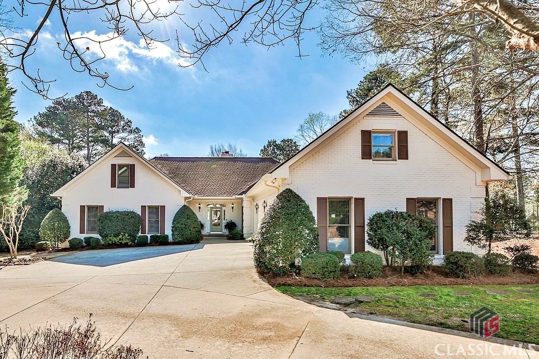 Just listed in Jennings Mill Country Club, Oconee County's premier golf course community. Located on a stunning homesite, this property overlooks the fairway of the 6th hole. The circular driveway makes for a beautiful entrance to this recently painted brick home. The main level features open living spaces, brick surround fireplace with gas logs, additional living room with large windows on three sides that have beautiful golf course views! The kitchen was recently updated with painted cabinets, marble counter tops, double ovens and gas cooktop. The oversized 3 car garage has additional space for storage and an extra fridge. There are 3 bedrooms on the main level, including the primary suite with walk-in closet, double vanity and separate sub and shower. Upstairs there are 2 bedrooms and 1 full bathroom. 30 year architectural roof is less than 2 years old! Membership to the country club is optional, and includes 18 holes of golf, driving range, an impressive tennis program, pickleball, clubhouse, restaurant, playground and pool. Zoned for the award winning North Oconee schools and convenient to Athens, UGA, dining, grocery and major access roads.