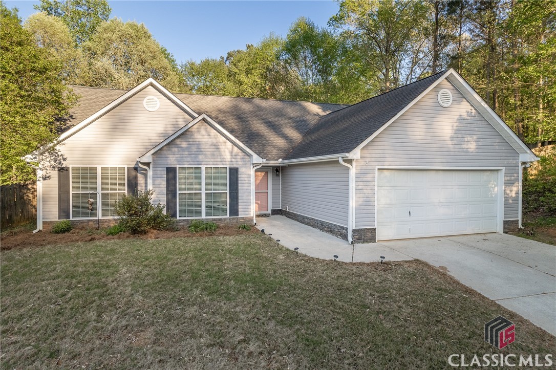 An abundance of upgrades and significant landscaping improvements make this Winterville home move-in-ready! One-level living with no steps to entry at front door and garage. All carpeting was replaced with LVP flooring in 2020, new stainless steel appliances in 2021, and large concrete patio added plus pebble pathways ending at a fire pit. The backyard is fully fenced with a combination of wood privacy fencing and horse fencing. Multiple River Birch trees provide shade on one of the largest lots in Pine Ridge Subdivision - 2.64 acres! The lot even abuts a creek! The Greatroom features a wood burning fireplace and vaulted ceiling. The eat-in kitchen features a breakfast nook, pantry and bar seating. A laundry room is located off of the kitchen, and the washer & dryer convey with the sale along with all other appliances. Owner's Suite is bright and cheery and features a trey ceiling. Ensuite bathroom has a soaking tub, double vanity, and separate shower. Two car attached garage. Make your appointment today to see this well maintained home!