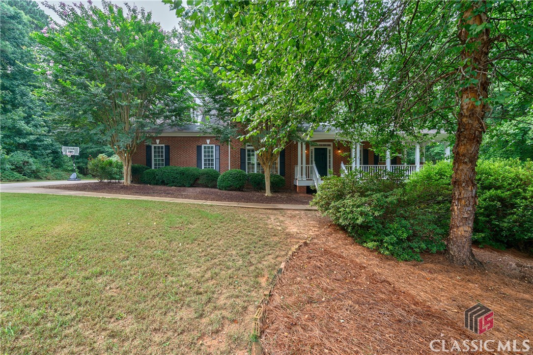 Located in the coveted North Oconee School District, 1030 Hardwood Court sits on over 1.6 acres in the swim and tennis community of Hickory Ridge subdivision in Oconee County GA. This property offers a private serene backdrop nestled on a corner lot in a cul-de-sac surrounded by trees and a backyard English garden, including a large pergola with swings, a custom hot tub, and screened in back porch. Upon entering you will be greeted with a two story foyer filled with natural light. To the right is a spacious office area with french doors for privacy. Directly across the foyer is a private dining room, perfect for entertaining. An entry way will take you into a stunning remodeled full custom kitchen with marble countertops and backsplash, a farmhouse fireclay kitchen sink with polished nickel bridge faucet and a butlers pantry providing ample amounts of storage! Upstairs is the owners suite with a fully renovated master bath including a free standing cast iron pedestal tub with deck mount telephone faucet fixtures, a custom designed vanity with quartz top, and a custom glass and tile shower. 3 additional large bedrooms with 2 full bathrooms and a bonus room! Almost all of the flooring and lighting has been updated throughout the house. This home also provides a finished basement which includes a full kitchen, and additional full bathroom and entertainment space.