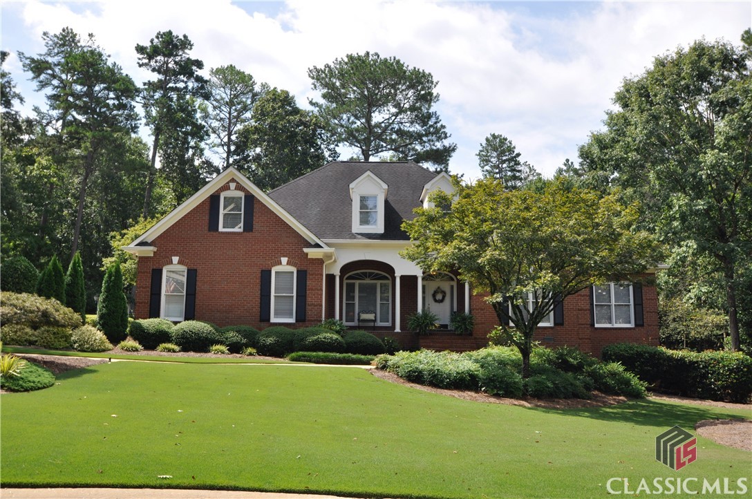 Located in the North Oconee school district and in the popular Jennings Mill Golf community is this four-sided brick home bursting with charm. Truly a gem, this one-owner estate has been meticulously maintained and cared for over the last 25+ years. Just off the covered porch is the warm and welcoming foyer that opens up into the main living areas of the home. The open concept dining room features a tray ceiling, drop-in lighting, and is lined with elegant columns. The tremendous great room boasts a cathedral ceiling, cozy fireplace, and built-in shelving and cabinets for extra storage. Quite spacious, the vibrant household kitchen complete with an abundance of white cabinets, smooth Corian countertops, tile backsplash, roomy island, recessed lighting, and a sizable pantry. There is plenty of space to cook for any gathering or holiday! Beyond the kitchen is a bright and airy keeping room/sunroom where you can relax and enjoy views of the private backyard. On the main level are three of the household bedrooms including the owner's suite with its own lavish, private bathroom. The laundry room provides cabinets, shelves, and a sink for spot cleaning. Upstairs is a grand bonus room and another  private bedroom and full bathroom, making it great for a guest area or teen suite. Below is an unfinished basement accessed from the outside to lend additional storage space. Tons of beautiful landscaping and lawn space - an  you even get your own putting green!
This property is just conveniently located literally inside  a golf course country club with pool, tennis and other amenities as well as minutes to  multiple medical offices, tons of dining, shopping, and entertainment. Zoned for North Oconee schools.