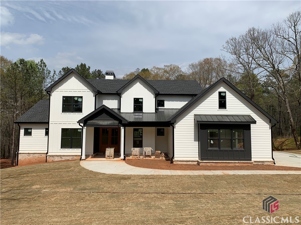 This modern farmhouse is situated on 6.562 acres off of idyllic Gober Road in Oconee County and is currently being custom built to include stunning finishes and thoughtful details throughout! STATS: *Estimated Completion May 2024 *5 Beds, 4 Baths *6.562 Acres *3900 Fin SqFT w/ partially finished basement; additional 750 Unfin SqFt in basement for 4649 total SqFt LAYOUT: *First Floor: Foyer, Great Room w/ Open Kitchen, Dining, and Sitting Rooms, Laundry Room, Mud Room, Full Bath, Owner's Suite, Office or Additional Bedroom, Screened Porch *Second Floor: 2 Bedrooms w/ Walk-In Closets and Jack-N-Jill Bath w/ Separate Vanities, Additional Owner's Suite *Basement: Finished Family Room, Unfinished Storage, 2 Potential Additional Bedrooms, and Plumbing for 2 Additional Baths FINISHES: *Modern Farmhouse Kitchen with Off-White Upper Cabinets and Misty Blue Bottom Cabinets *Granite Countertops in Kitchen and Baths *Black Fixtures *Glass Shower Surrounds in Owner's Suite Baths, *Engineered Flooring w/ Some Carpeting