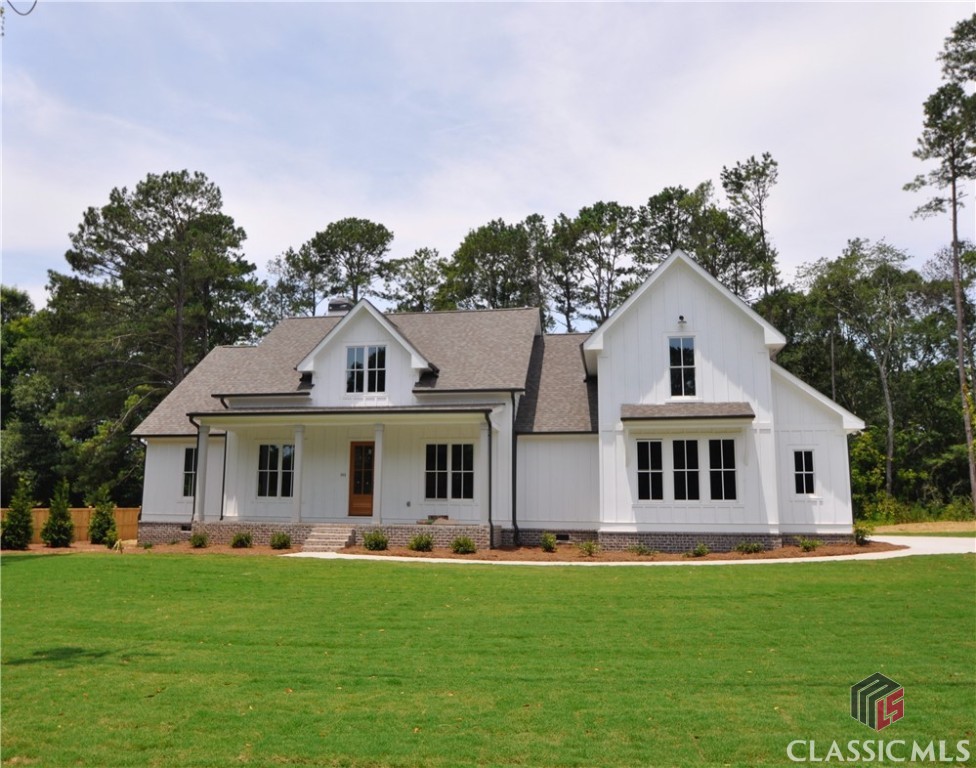 Prepare to fall in love with this incredible new construction residence conveniently located less than five minutes from downtown Watkinsville. Quite substantial, this rural homestead encompasses five bedrooms and four and a half bathrooms in nearly 3,200 sq ft. Masterfully crafted with an open design, fine appointments include coffered ceilings, shiplap walls, modern light fixtures, wood floors, ample storage, and more. The home's interior offers a dining room upon entry that leads into the spacious great room complete with a cozy fireplace and tons of natural light. The distinguished eat-in kitchen has everything you could want or need from gleaming quartz counters to counter and cabinet space galore. Truly a gem, the owner's retreat features high ceilings, wood floors, and a bathroom with a stand-up tile shower, pedestal soaking tub, and dual sink vanity. Three additional bedrooms, each with plenty of closet space and a ceiling fan, occupy the main level along with two other full bathrooms and one half bathroom . Upstairs provides another large bedroom and its own full bathroom. The covered back deck is where you'll want to spend much of your time as it is considerable enough to entertain, is screened-in, and provides an outdoor fireplace where you can relax and keep warm, even on a cool fall night. This Oconee County oasis sits on .81 acres and is easily accessible to 441, Greensboro Hwy, or US-316.