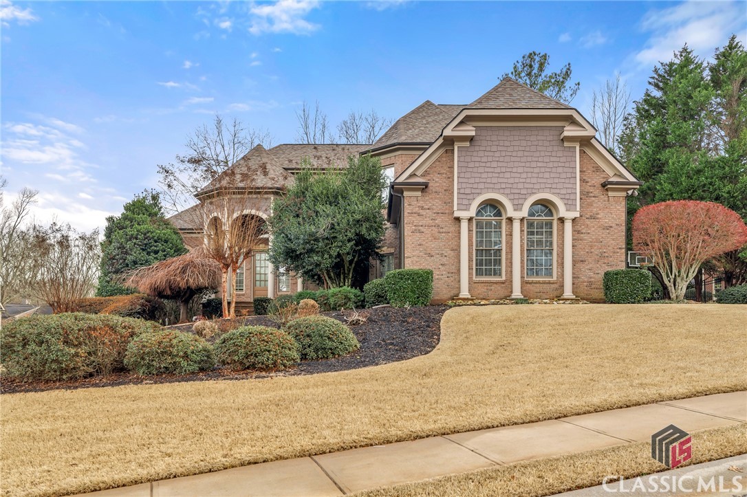 Just listed in Oconee County's best selling luxury community - Rowan Oak! Tucked away on a corner lot, this homesite is one of the largest in this section of the neighborhood and has a lot of mature landscaping to give added privacy. This all brick home has been well maintained and the primary suite is on the main level and has a fireplace, two walk-in closets with custom shelving. Large living room is connected to the dining room, that leads to the kitchen, fireside keeping room and breakfast area. Upstairs there are three bedrooms, three full bathrooms and a large loft area. The finished terrace level has plenty of space to entertain and a home theater, plus a bedroom and full bathroom. Level fenced-in back yard, irrigation, three car garage. Gated community with swim/tennis/pickleball/walking trails, all located very close to shopping, grocery, dining and award winning schools. This is a great price point for Rowan Oak, leaving room to personalize the details.